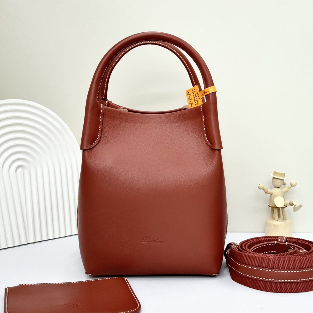 Loro piana Bale Medium Bucket Bag: We offer FREE SHIPPING for both domestic and international clients who bid over $500. The Loro Piana Bale Medium Bucket Bag in Red Plain Jaw is crafted from premium calfskin leather with a suede linin