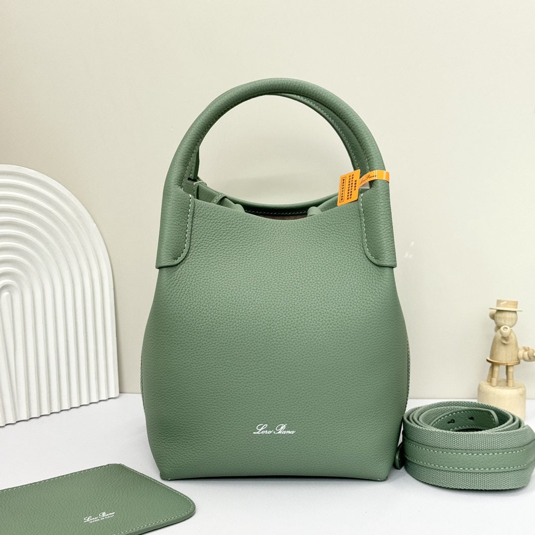 Loro piana Bale Medium Bucket Bag: We offer FREE SHIPPING for both domestic and international clients who bid over $500. The Loro Piana Bale Medium Bucket Bag in Artemisia Leaf Green is crafted from premium calfskin leather with a sued