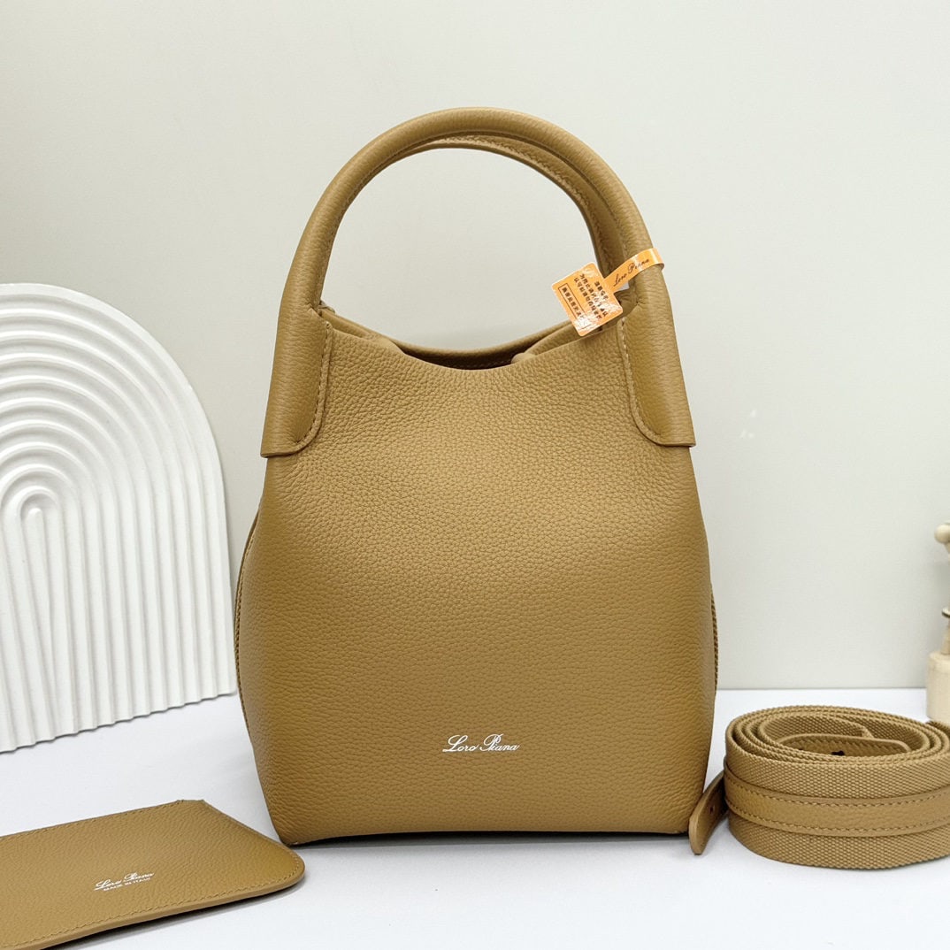 Loro piana Bale Medium Bucket Bag: We offer FREE SHIPPING for both domestic and international clients who bid over $500. The Loro Piana Bale Medium Bucket Bag in ginger yellow is crafted from premium calfskin leather with a suede linin
