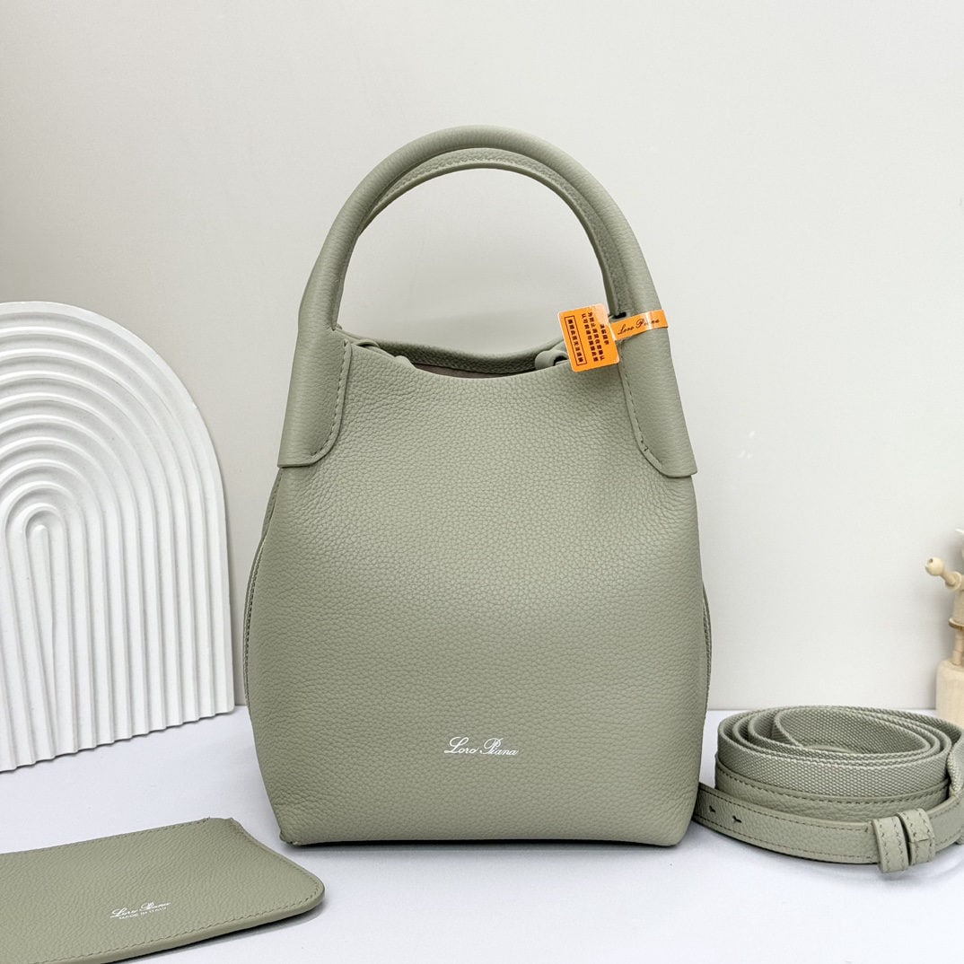 Loro piana Bale Medium Bucket Bag: We offer FREE SHIPPING for both domestic and international clients who bid over $500. The Loro Piana Bale Medium Bucket Bag in Mustard Green is crafted from premium calfskin leather with a suede linin