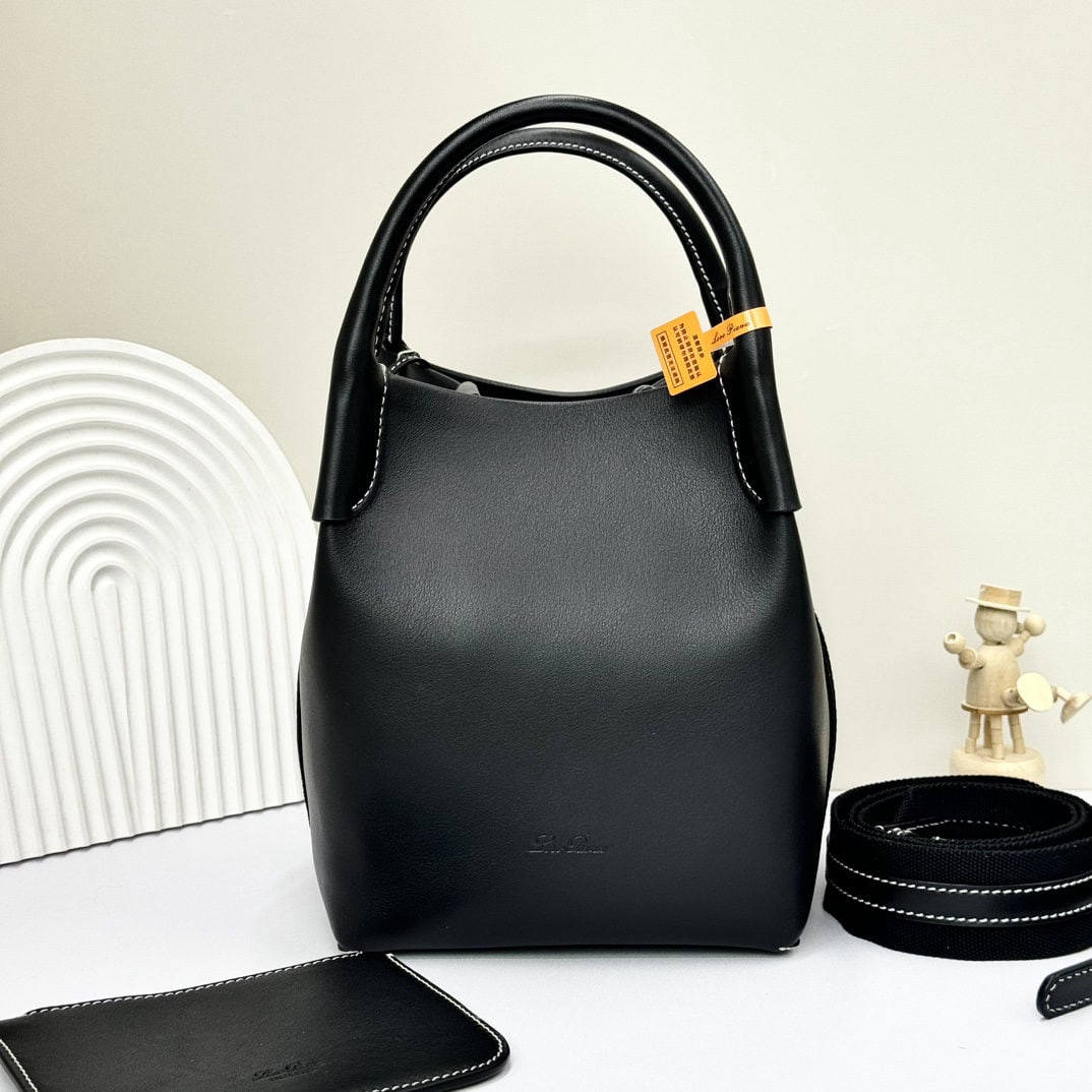 Loro piana Bale Medium Bucket Bag: We offer FREE SHIPPING for both domestic and international clients who bid over $500. The Loro Piana Bale Medium Bucket Bag in Black Plain Weave is crafted from premium calfskin leather with a suede l