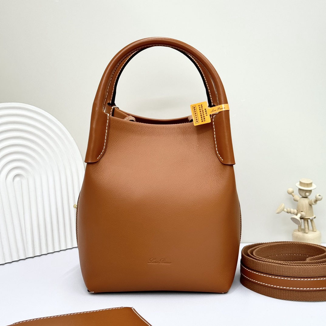 Loro piana Bale Medium Bucket Bag: We offer FREE SHIPPING for both domestic and international clients who bid over $500. The Loro Piana Bale Medium Bucket Bag is crafted from premium calfskin leather with a suede lining. It features a 