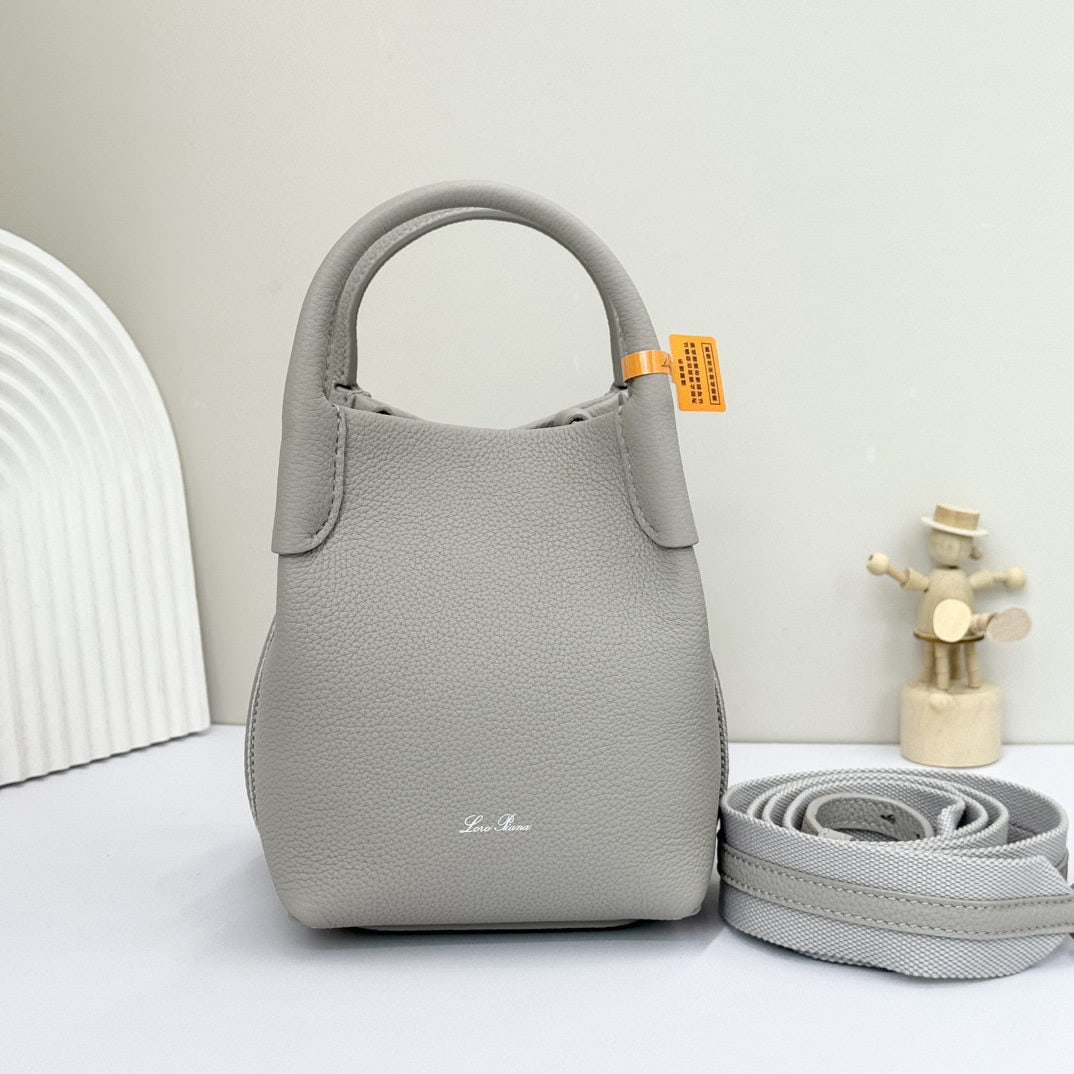 Loro piana Bale Mini Bucket Bag: We offer FREE SHIPPING for both domestic and international clients who bid over $500. The Loro Piana Bale Mini Bucket Bag in Dusty Stone Grey is crafted from signature Flower denim, featuring hand-sti
