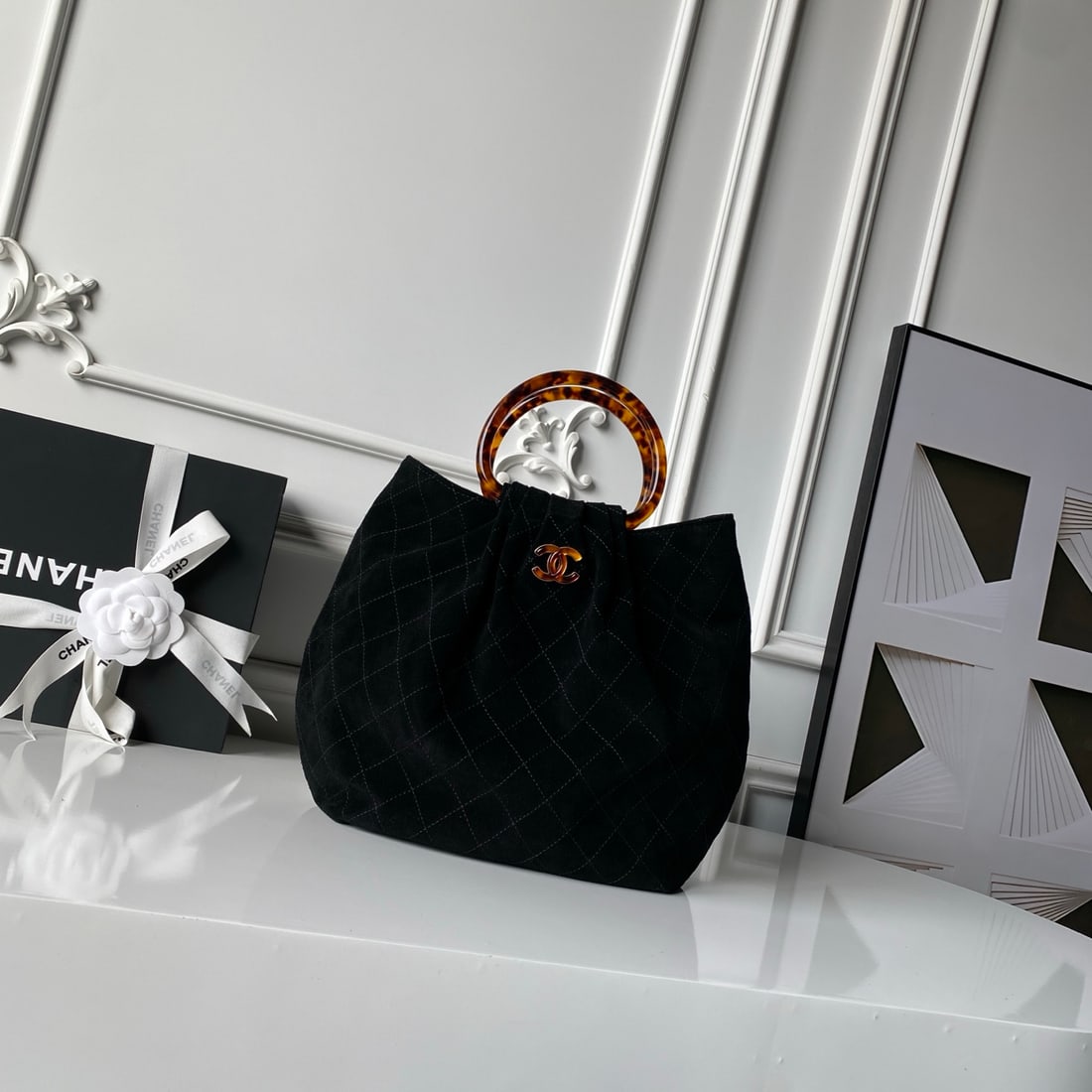 CHANEL suede bucket bag with tortoiseshell handles: We offer FREE SHIPPING for both domestic and international clients who bid over $500. The CHANEL bucket bag features a tortoiseshell handle and suede upper. The body is crafted from suede, a supple an