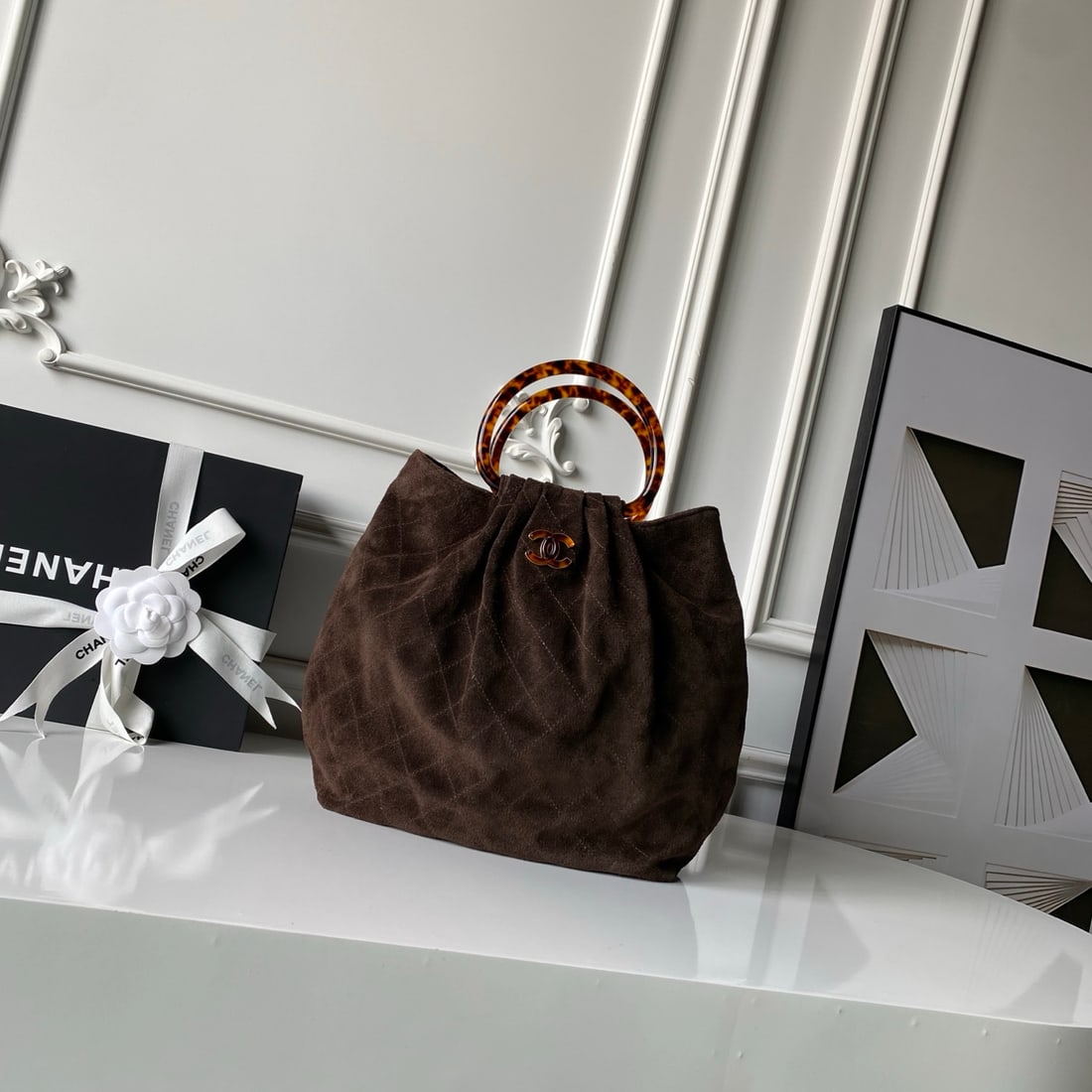 CHANEL suede bucket bag with tortoiseshell handles: We offer FREE SHIPPING for both domestic and international clients who bid over $500. The CHANEL bucket bag features a tortoiseshell handle and suede upper. The body is crafted from suede, a supple an