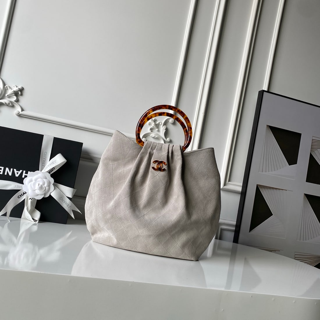 CHANEL suede bucket bag with tortoiseshell handles: We offer FREE SHIPPING for both domestic and international clients who bid over $500. The CHANEL bucket bag features a tortoiseshell handle and suede upper. The body is crafted from suede, a supple an