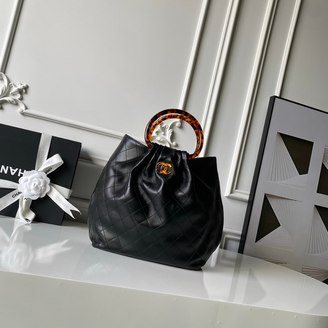 CHANEL bucket bag with tortoiseshell handle: We offer FREE SHIPPING for both domestic and international clients who bid over $500. The CHANEL bucket bag with tortoiseshell handles is crafted from imported lambskin, its leather supple and smooth.