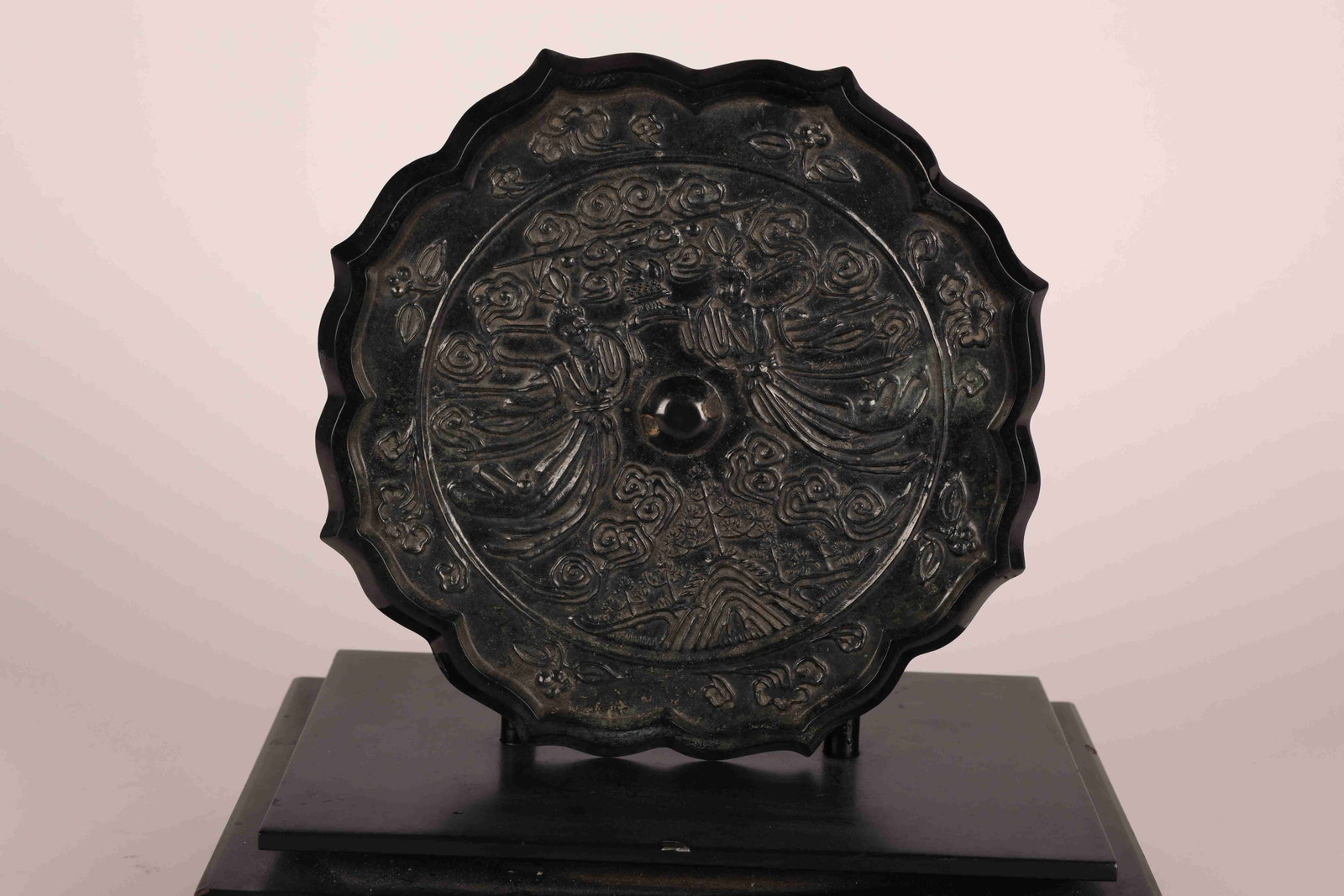 Tang Dynasty "Heavenly Maiden" Bronze Mirror: Tang Dynasty "Heavenly Maiden Scattering Flowers" Mallow-Rim Bronze Mirror. Tang Dynasty, 618-907 AD. Diameter: 21.7cm Depth: 0.8cm Weight: 1502g. Description: A cast bronze mirror of eight-lobed mall