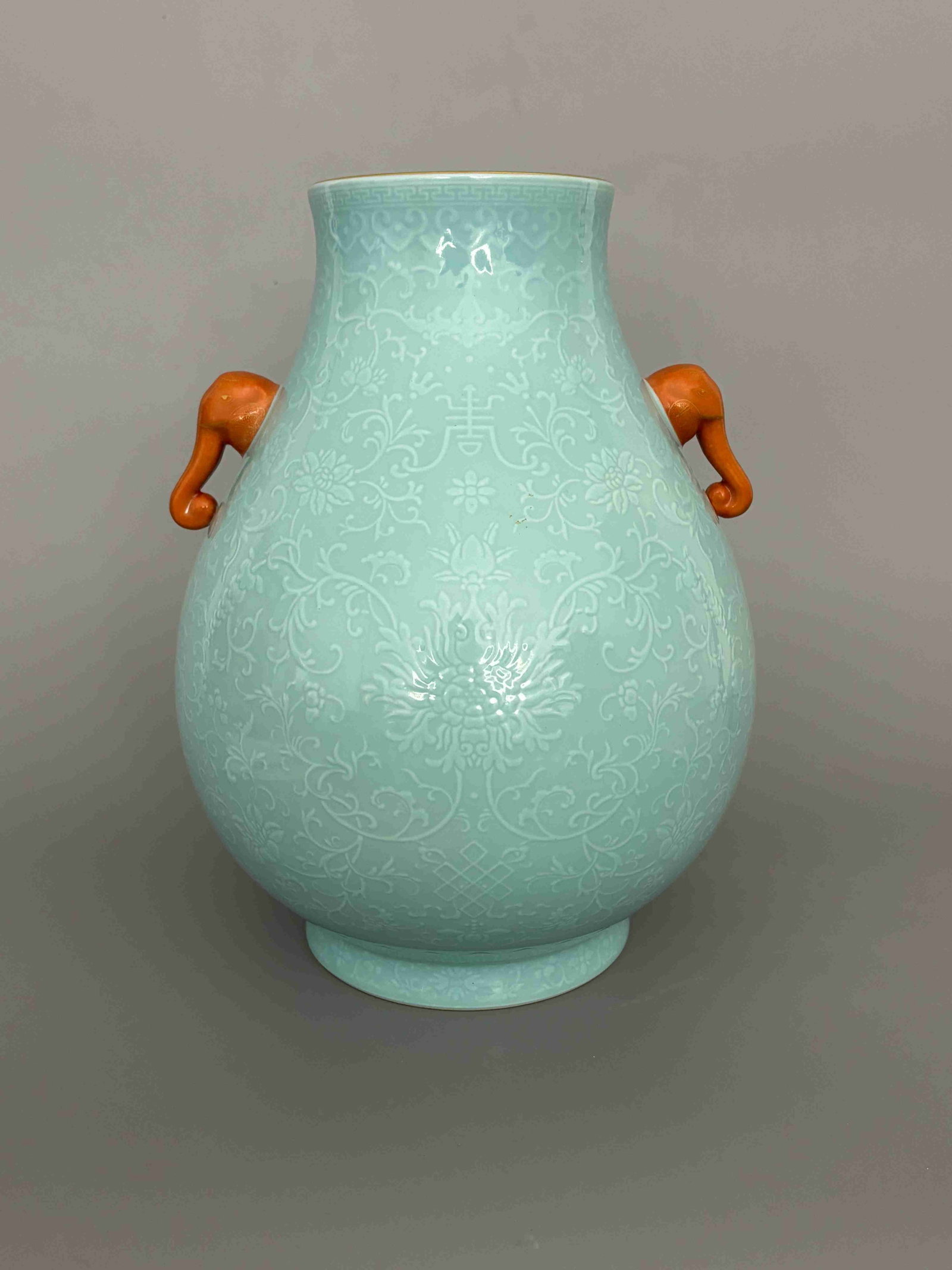 Qing Qianlong Scrolling Lotus Okra-Glazed: Qing Qianlong Scrolling Lotus Okra-Glazed Elephant-Handle Zun VaseQing Dynasty, Qianlong Period, 1736-1795Height: 28.3cm Mouth Diameter: 10.5cm Base: 12.9cmDescription: A vase of pear-shaped body risi