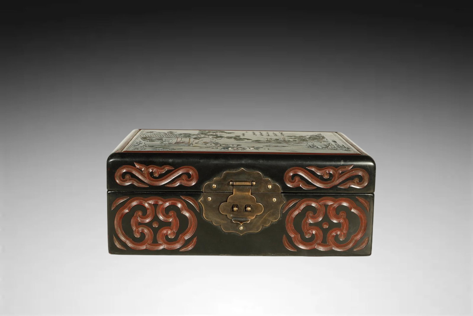 Qing Dynasty Carved Lacquer and Painted Panel Box: AN OUTSTANDING CARVED LACQUER AND PA INTED PANEL BOX. Qing Dynasty, Qianlong Period (1736–1795)Height:10.5cm Length:26.5cm Width:18cm. Description: Of rectangular form with a hinged cover and metal 