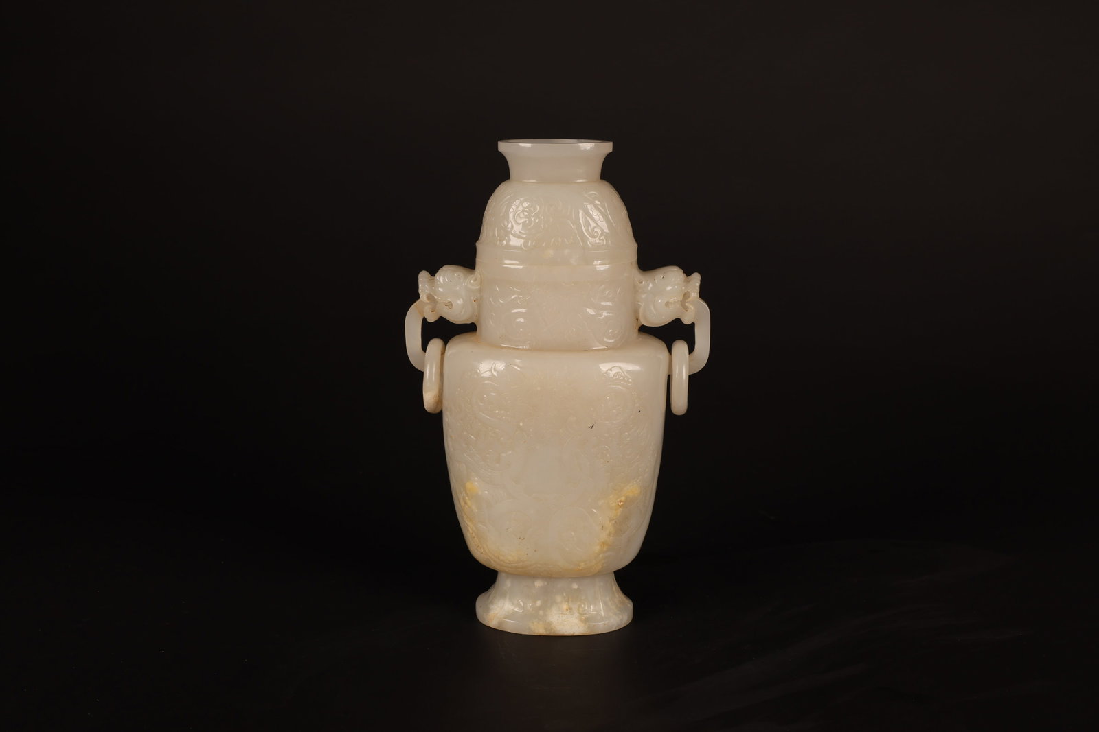 Ming Dynasty Hetian Jade Ring-Handle Vase: Ming Dynasty Hetian Jade Ring-Handle VaseMing DynastyHeight: 23cm Width: 8.5cm Foot Diameter: 5.5cmDescription: A covered-form vase, its cover now lacking, carved from a fine white Hetian-type jade, t
