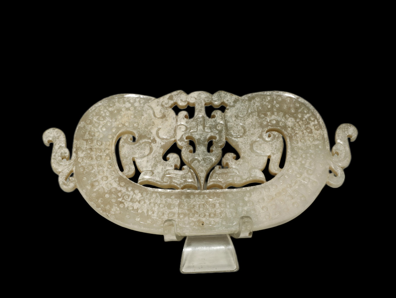 Han Dynasty Jade Openwork 'Double-dragon' Pendant: A RARE AND FINELY CARVED CELADON JADE OPENWORK 'DOUBLE-DRAGON' PENDANTWestern Han Dynasty, circa 206 BC–AD 8Length 14.5 cm × Width 12 cmDescription: This substantial pendant is carved as a symmetri