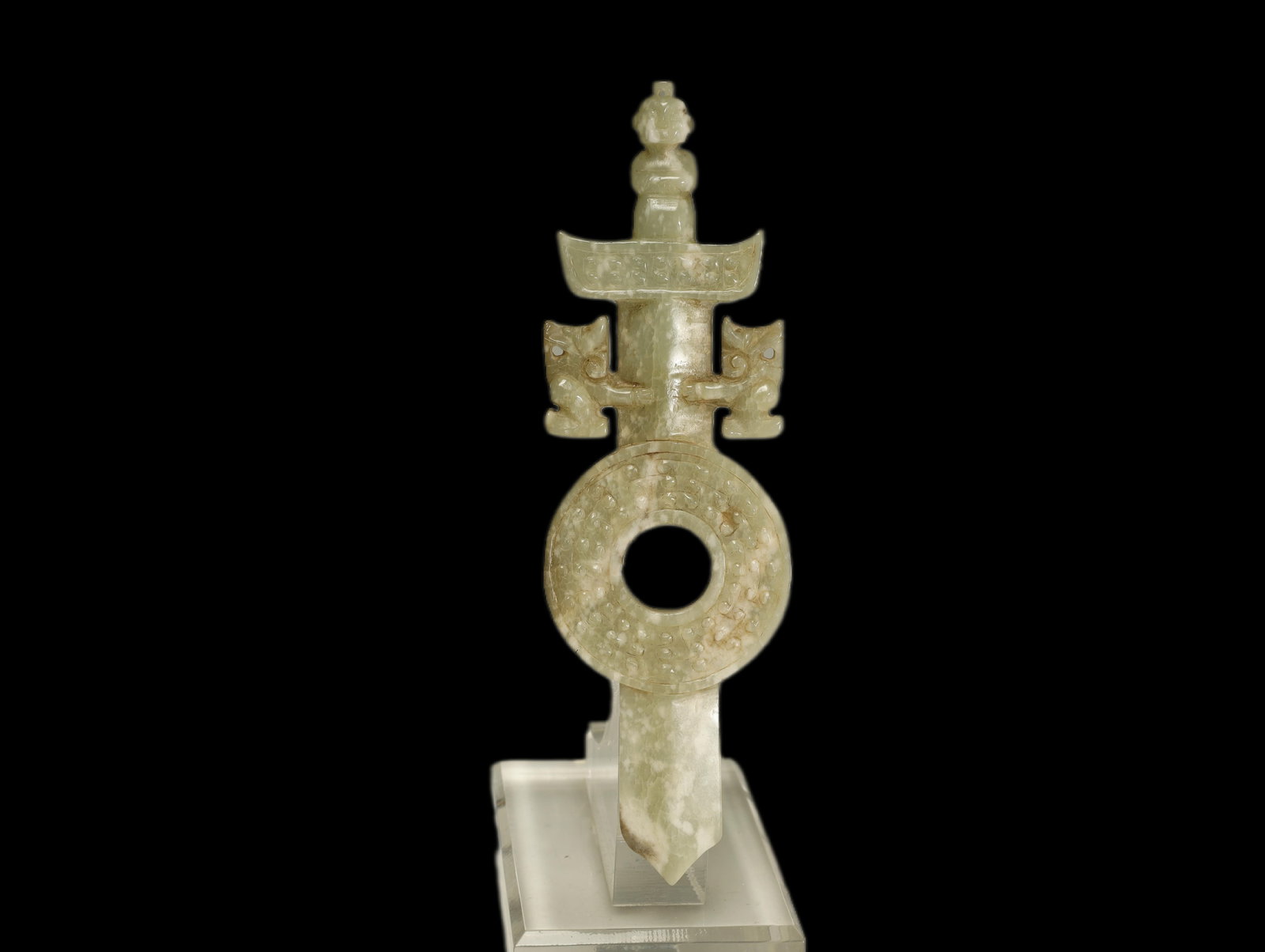 Han Dynasty CELADON JADE SWORD-FORM CEREMONIAL: A RARE AND FINELY CARVED CELADON JADE SWORD-FORM CEREMONIAL PENDANT WITH BI-DISC AND BEAST FINIALSHan Dynasty, circa 206 BC–AD 220Length 15 cm × Width 4.6 cmDescription: This elaborate ceremonial j