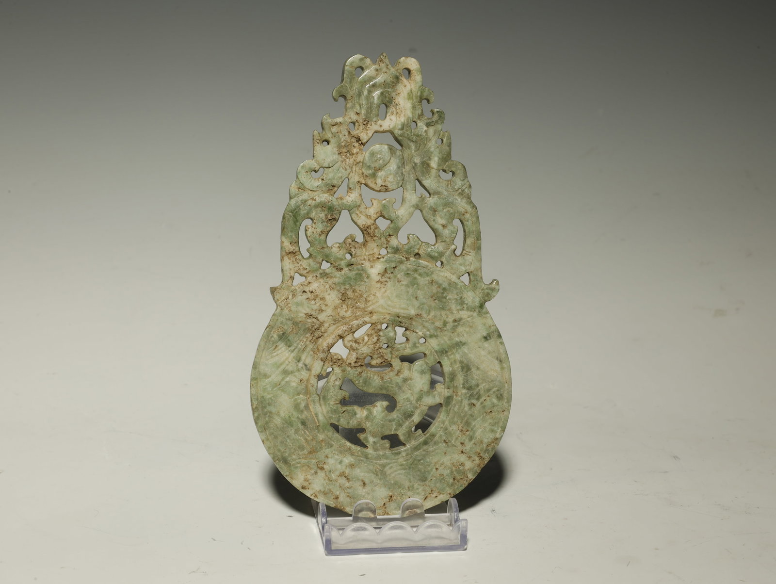 Han Dynasty Double?dragon Openwork Jade Bi Disc: A FINE HAN DYNASTY DOUBLE?DRAGON OPENWORK JADE BI DISCChinese, circa 206 BCE–220 CELength 15.5 cm × Width 8.5 cmDescription: Superbly carved in openwork relief, this bi disc features two confrontin