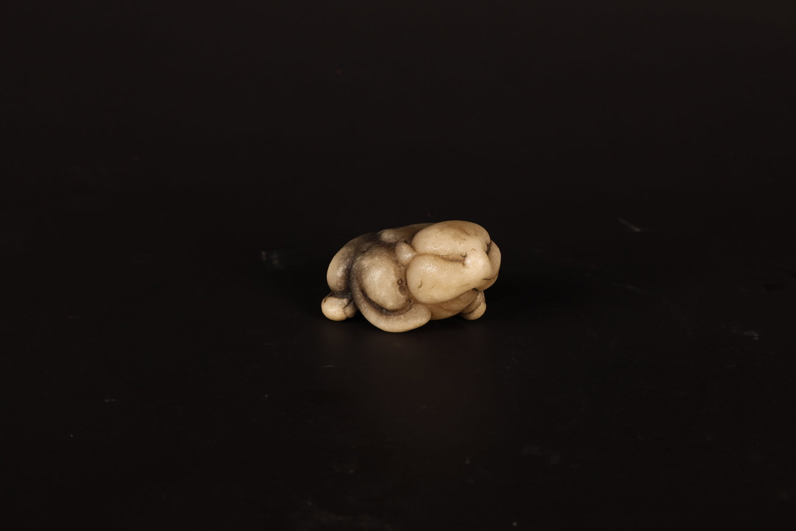Han Dynasty White Jade Toad: Han Dynasty White Jade Toad. Han Dynasty Length: 7.5cm Width: 4.8cm Height: 4.5cm. Description: A small jade carving of a crouching toad in pale, whitish-toned stone, the broad, rounded body and wide-