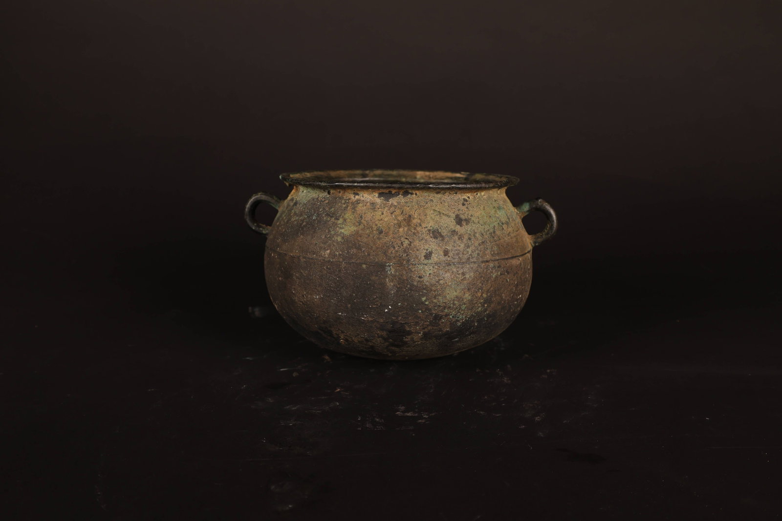 Han Dynasty Plain Twin-Handle Censer: Han Dynasty Plain Twin-Handle Censer. Han Dynasty. Height: 12cm Belly Diameter: 16.5cm. Description: A rounded bronze censer of compressed globular form, the plain body rising to a short, slightly eve