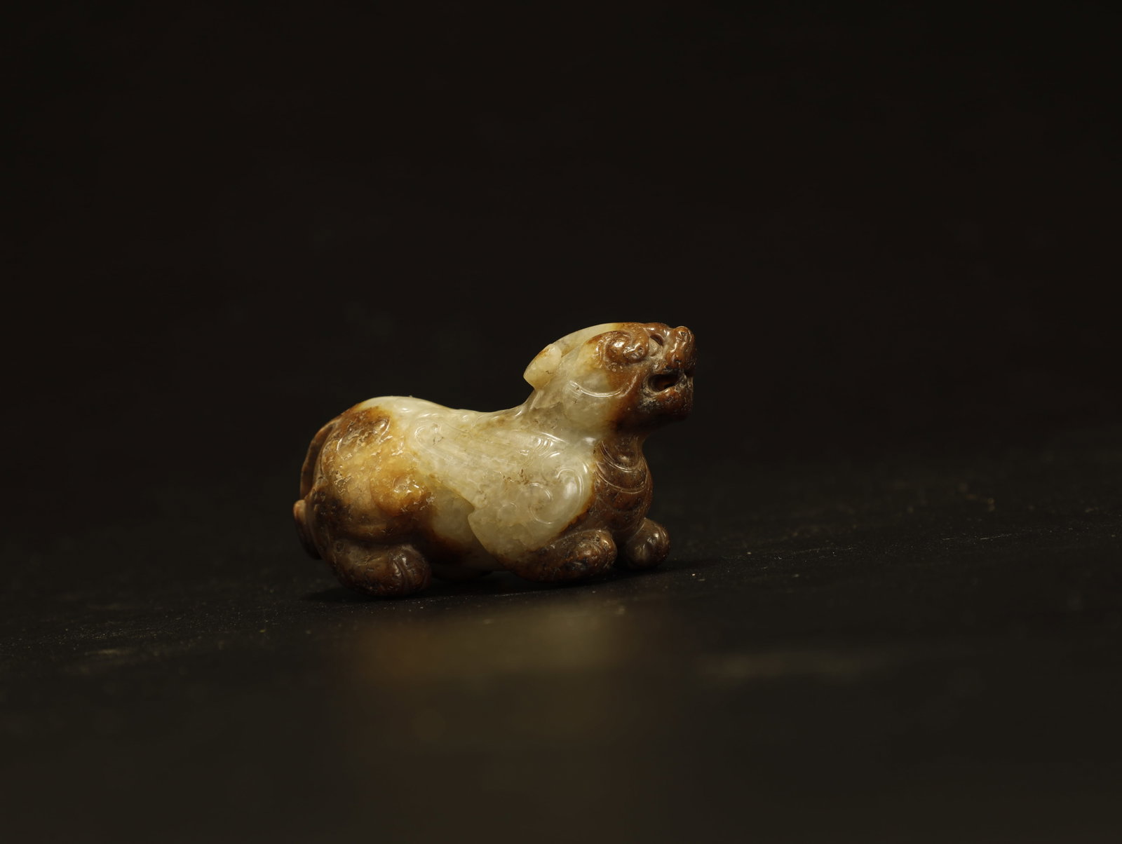 Chinese - 4th–6th Century Jade Carving of a: A Fine White and Russet Jade Carving of a Mythical BeastChinese, Northern and Southern Dynasties, circa 4th–6th Century ADHeight 3.5 cm × Length 2.5 cm × Width 5.5 cmDescription: A small jade carv