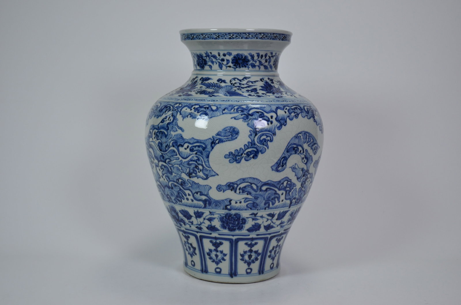 Qing Dynasty Blue-and-White Phoenix and Lotus: Qing Dynasty Blue-and-White Phoenix and Lotus Wave-Scroll JarQing DynastyHeight: 49cm Base Diameter: 20cmDescription: A baluster jar with waisted neck and everted, flanged mouth, the neck painted with