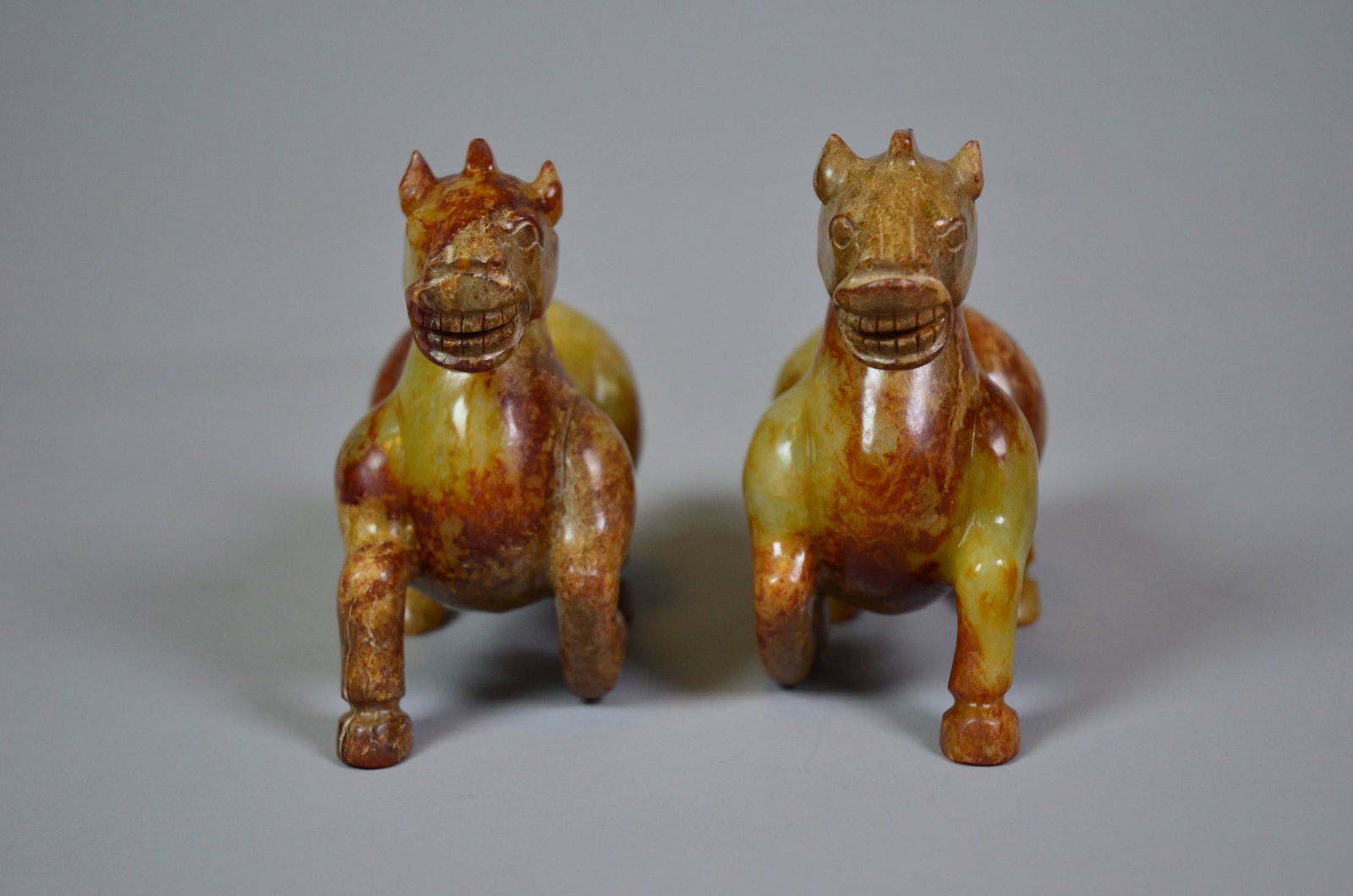 Han Dynasty Hetian Jade Standing Horse Carvings: Han Dynasty Hetian Jade Standing Horse Carvings, PairArchaistic StyleLength: 12.5cm Width: 5.5cm Height: 10.5cm Weight: 849gDescription: A pair of standing horses, each modeled foursquare on straight 