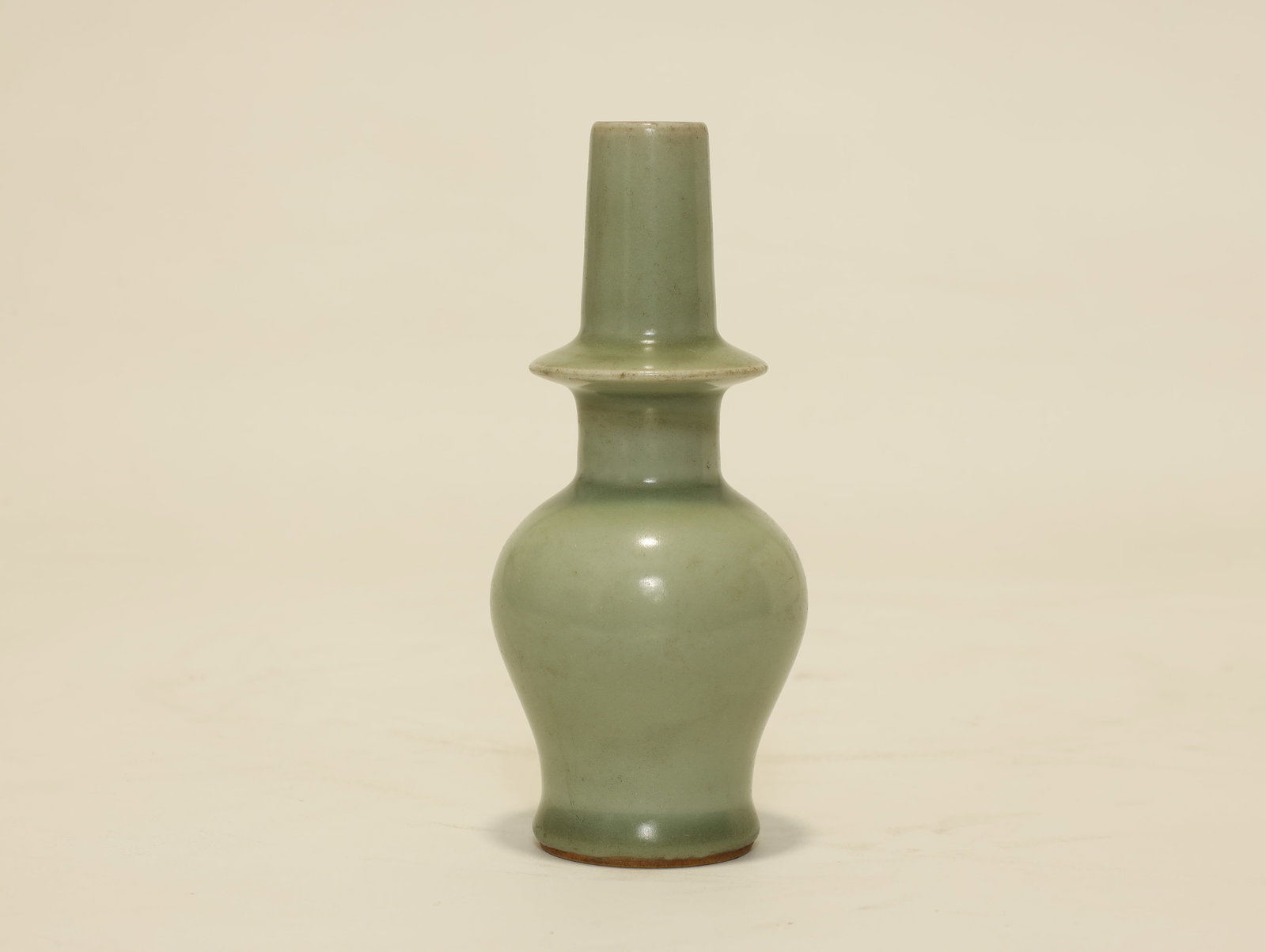 Qing Dynasty Longquan-Style Celadon 'Ji': Longquan-Style Celadon 'Ji' Character VaseChinese, Qing DynastyHeight 16.5 cmDescription: A celadon-glazed porcelain vase in the Longquan tradition, the body of gently swelling baluster form beneath a