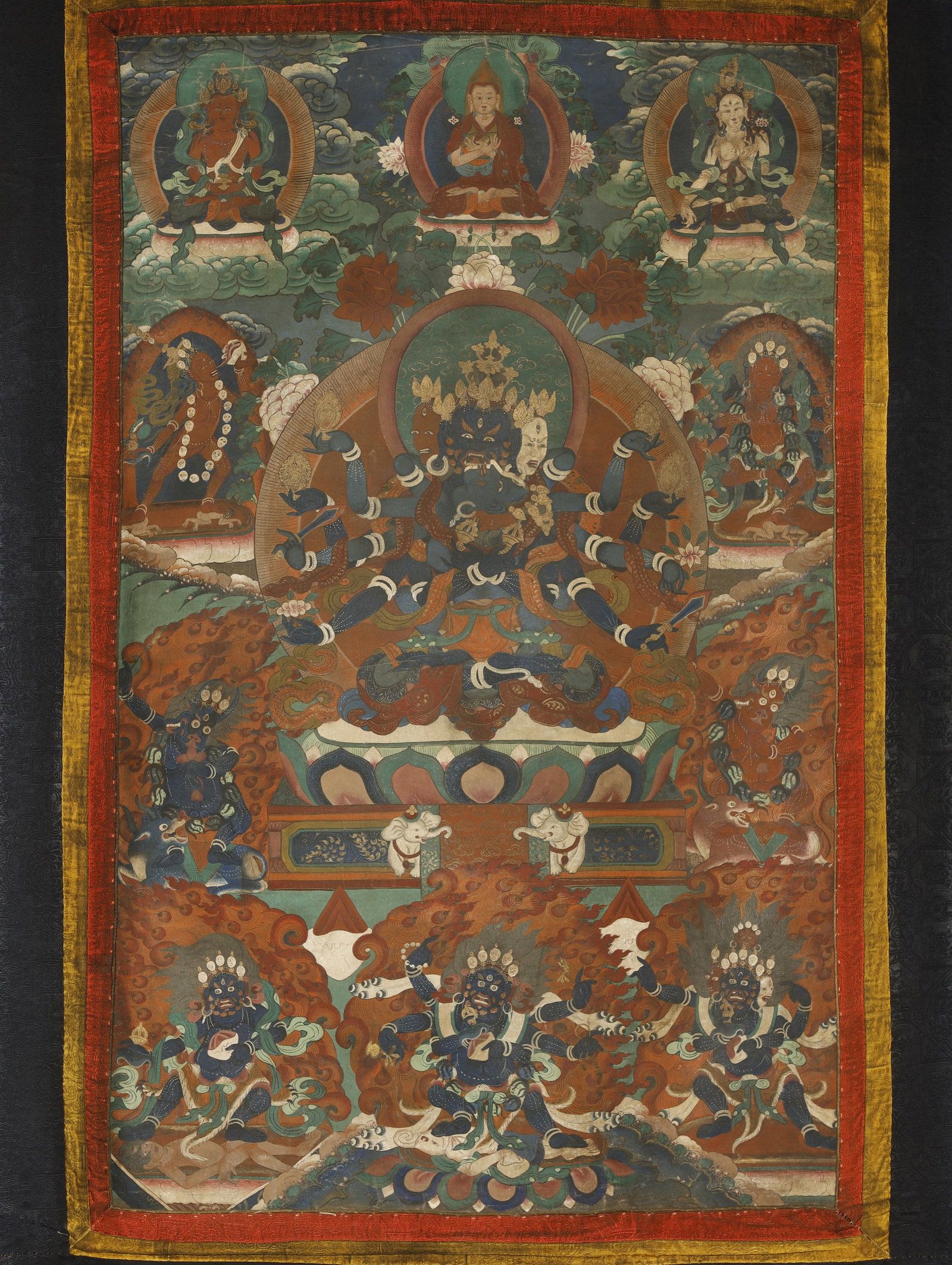 Qing Dynasty Thangka of Guhyasamaja: A Painted Thangka of GuhyasamajaChina/Tibet, Qing Dynasty35.4 x 22 in. (90 x 56 cm)Description: A hand-painted thangka depicting Guhyasamaja ('Secret Assembly'), the deep-blue multi-armed and multi-he
