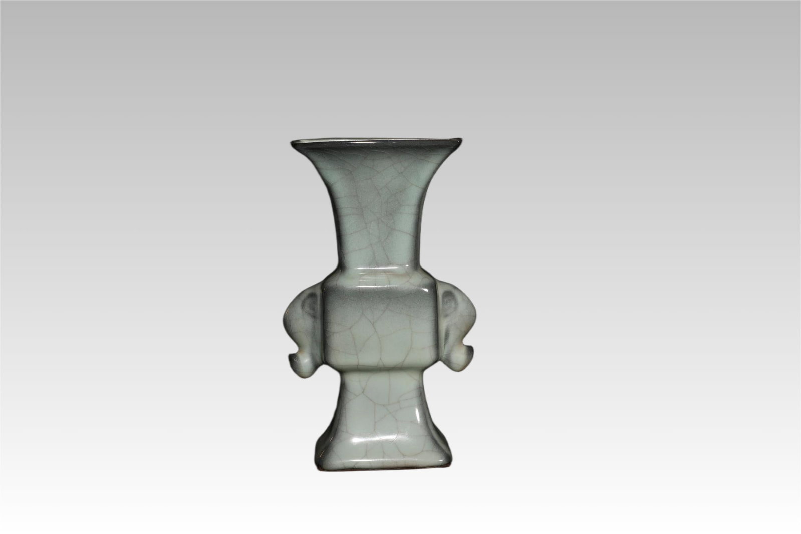 Qing Dynasty Powder-Blue Glazed Elephant-Handle Hu Vase: Imitation Song Guan-Type Powder-Blue Glazed Elephant-Handle Hu VaseChinese, Qing DynastyHeight 22.6 cm x Mouth Length 11.3 cm x Mouth Width 9 cmDescription: A hu-form vase of flattened oval section af