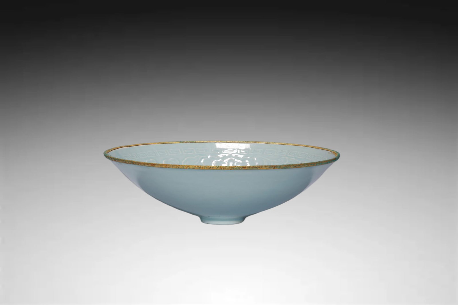Northern Song Celadon Carved-Petal Gilt-Rim Douli: Northern Song Celadon Carved-Petal Gilt-Rim Douli Cup...Chinese, Northern Song Dynasty style...Height 6 cm x Mouth Diameter 20.3 cmDescription: A wide, shallow douli ('reed hat') form cup, the flaring