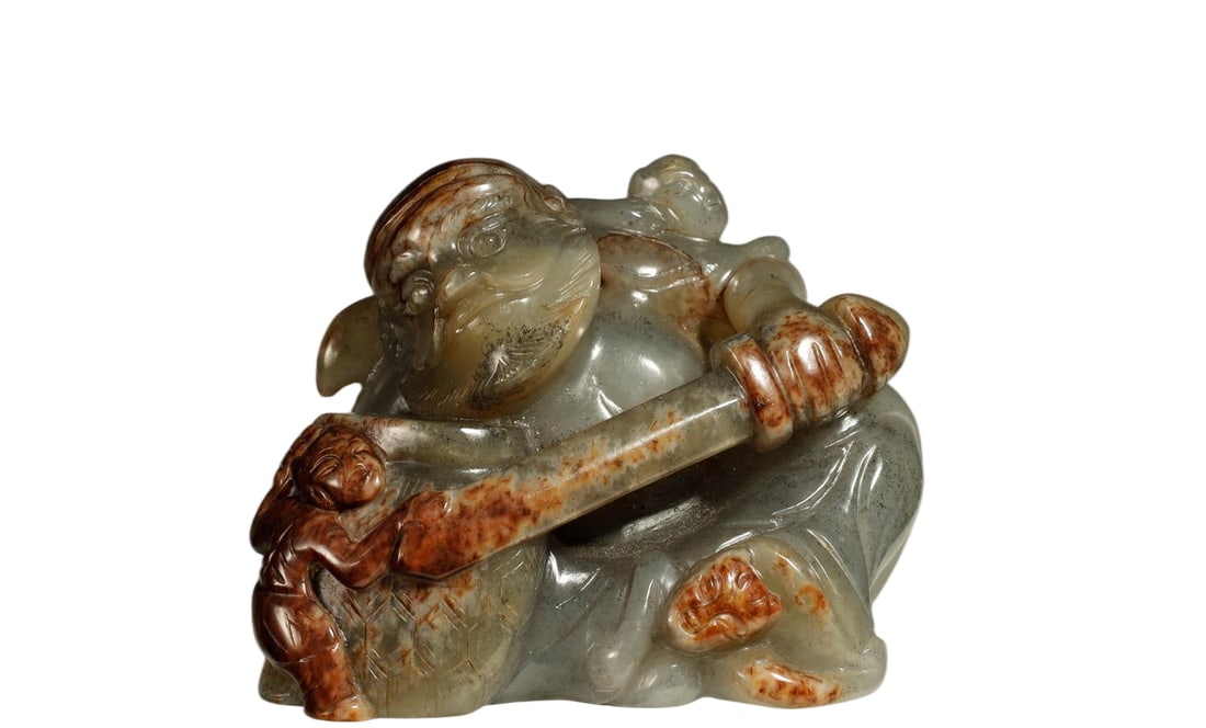 Chinese Hetian Jade 'Zhong Kui Catching Ghosts': Hetian Jade 'Zhong Kui Catching Ghosts' Hand-Held CarvingChineseHeight 6 cm x Length 6.5 cm x Width 4 cmDescription: A round-carved Hetian jade hand piece depicting the demon-queller Zhong Kui in dyna