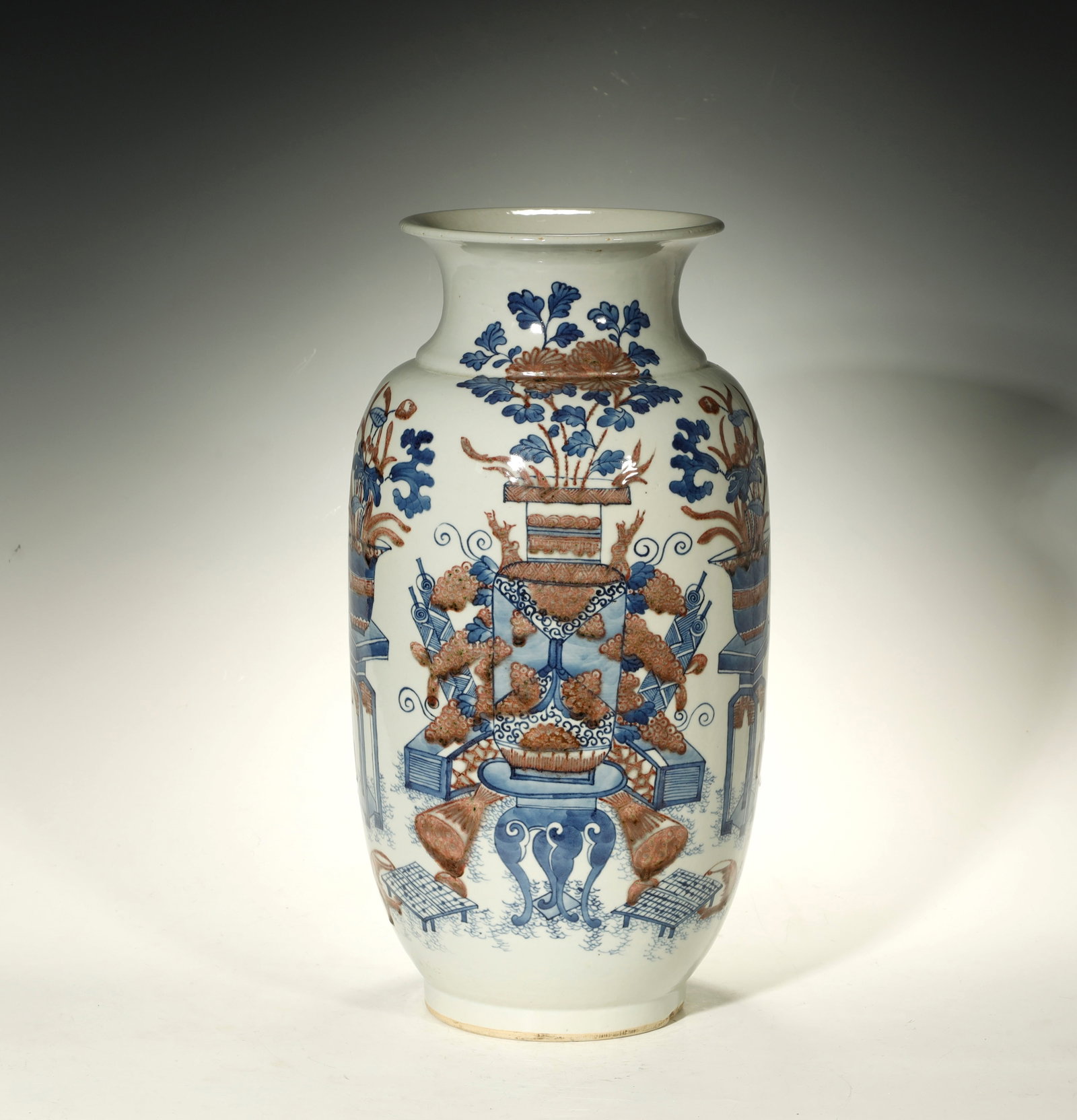 Qing Dynasty Blue-and-White and Copper-Red: A Blue-and-White and Copper-Red 'Bogu' Flaring-Mouth VaseChina, Qing DynastyHeight: 17.9 in. (45.5 cm); diameter 7.1 in. (18 cm)Description: A baluster vase with waisted neck and flaring mouth, painte