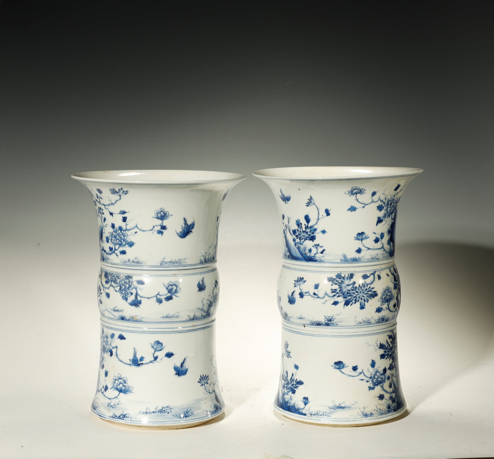 Qing Dynasty Pair of Blue-and-White Bird-and-Flower Gu-Form Vases (PAIR): A Pair of Blue-and-White Bird-and-Flower Gu-Form VasesChina, Qing DynastyHeight: 13.4 in. (34 cm); diameter 9.4 in. (24 cm)Description: A pair of gu-form beaker vases, each with a trumpet-flared mouth