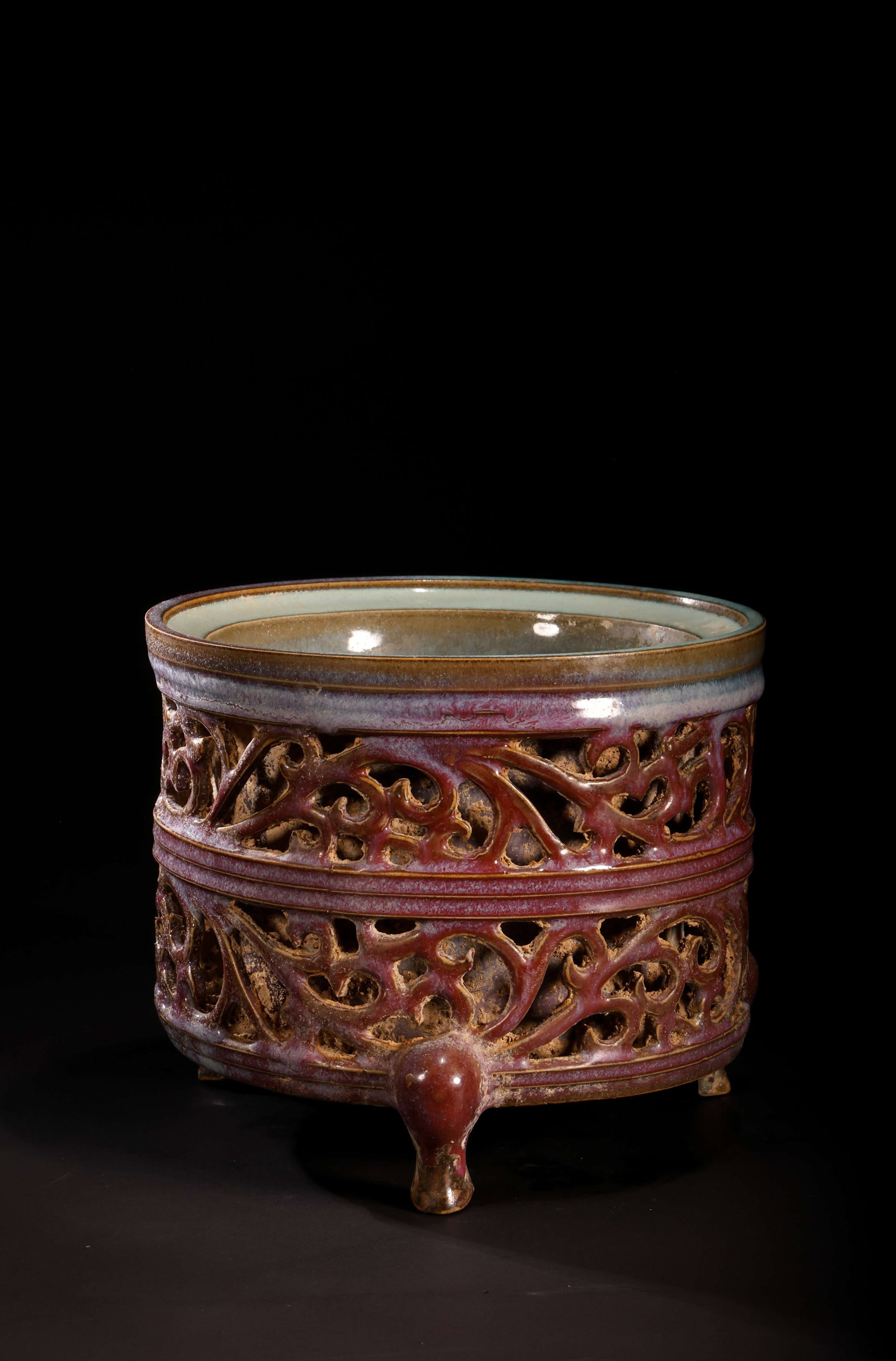 Song Dynasty Jun Ware Openwork Tripod Censer: Song Dynasty Jun Ware Openwork Tripod CenserSong DynastyHeight: 15.5cm Base / Foot: 17.5cmDescription: A cylindrical porcelain censer raised on three bracket feet, the body pierced overall with two re