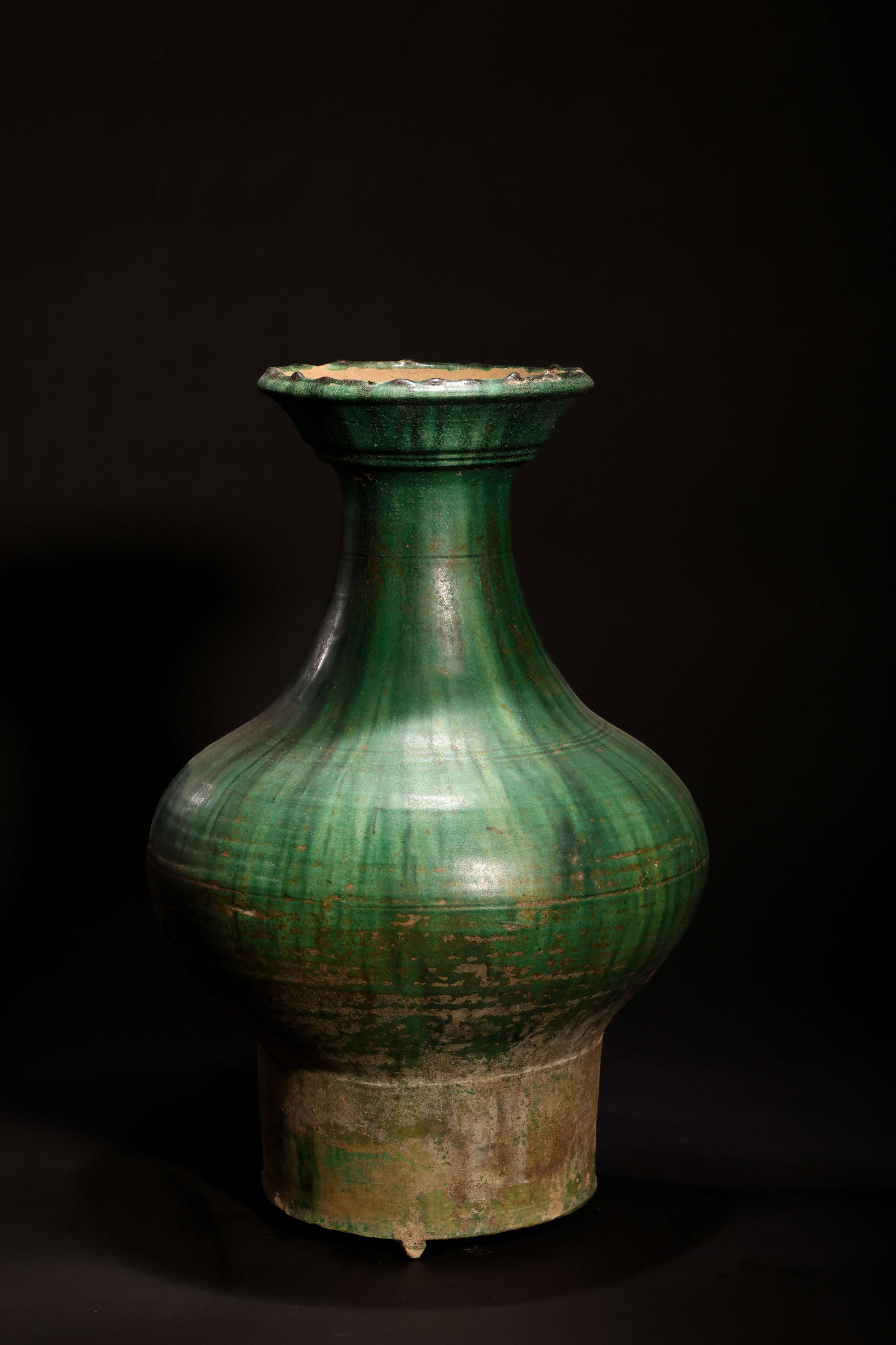 Han Dynasty Green-Glazed High-Foot Pottery Jar: Han Dynasty Green-Glazed High-Foot Pottery JarHan Dynasty (206 BC-220 AD)Height: 44cm Foot Diameter: 17.5cmDescription: A tall pottery jar of pear-shaped form, the flared trumpet mouth rising above a 