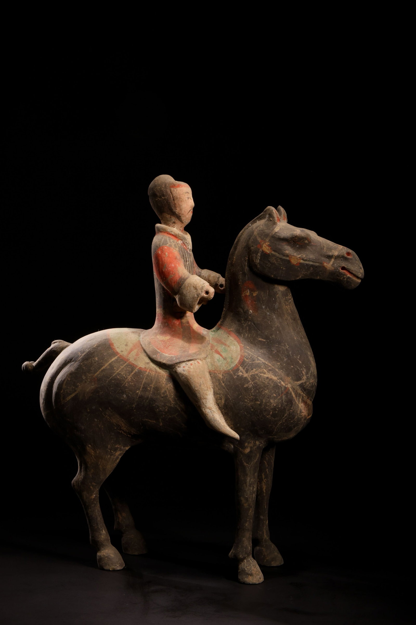 Tang Dynasty Black-Glazed Red-Painted Warrior: Tang Dynasty Black-Glazed Red-Painted Warrior FigurineTang Dynasty (618-907 AD)Height: 36cm Length: 35cm Width: 12cmDescription: A pottery figure of a standing horse with a rider mounted astride, the 