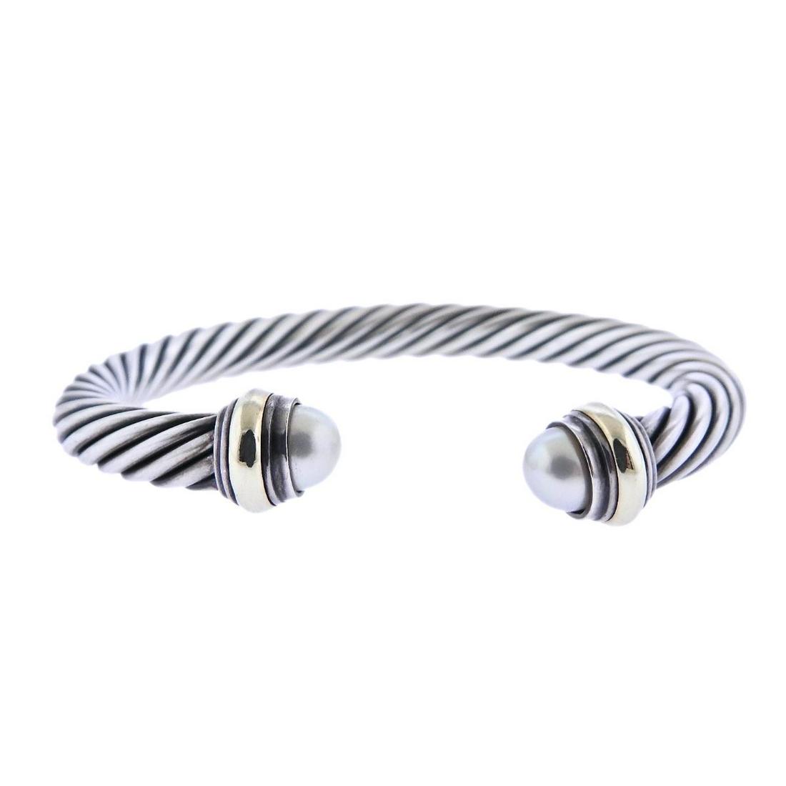 David Yurman Sterling Pearl Cuff Bracelet: Metal : Sterling/14k Gold Designer : David Yurman Gemstone : Pearl Measurements : Bracelet will fit approx. 7.5 - 8" wrist and is 11.3mm at widest point Marked: : 14k Sterling, Yurman