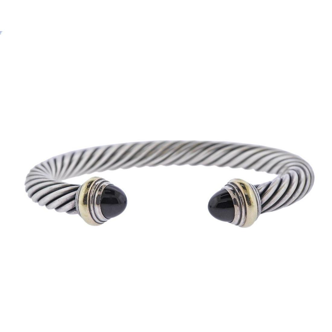 David Yurman Silver 14k Gold Onyx Cable Bracelet: Metal : 14k Gold/ Sterling Silver Designer : David Yurman Gemstone : Onyx Measurements : bracelet will fit approx. 7-7.25" wrist and is 7mm wide Marked: : D.Yurman, 925, 585 Weight: