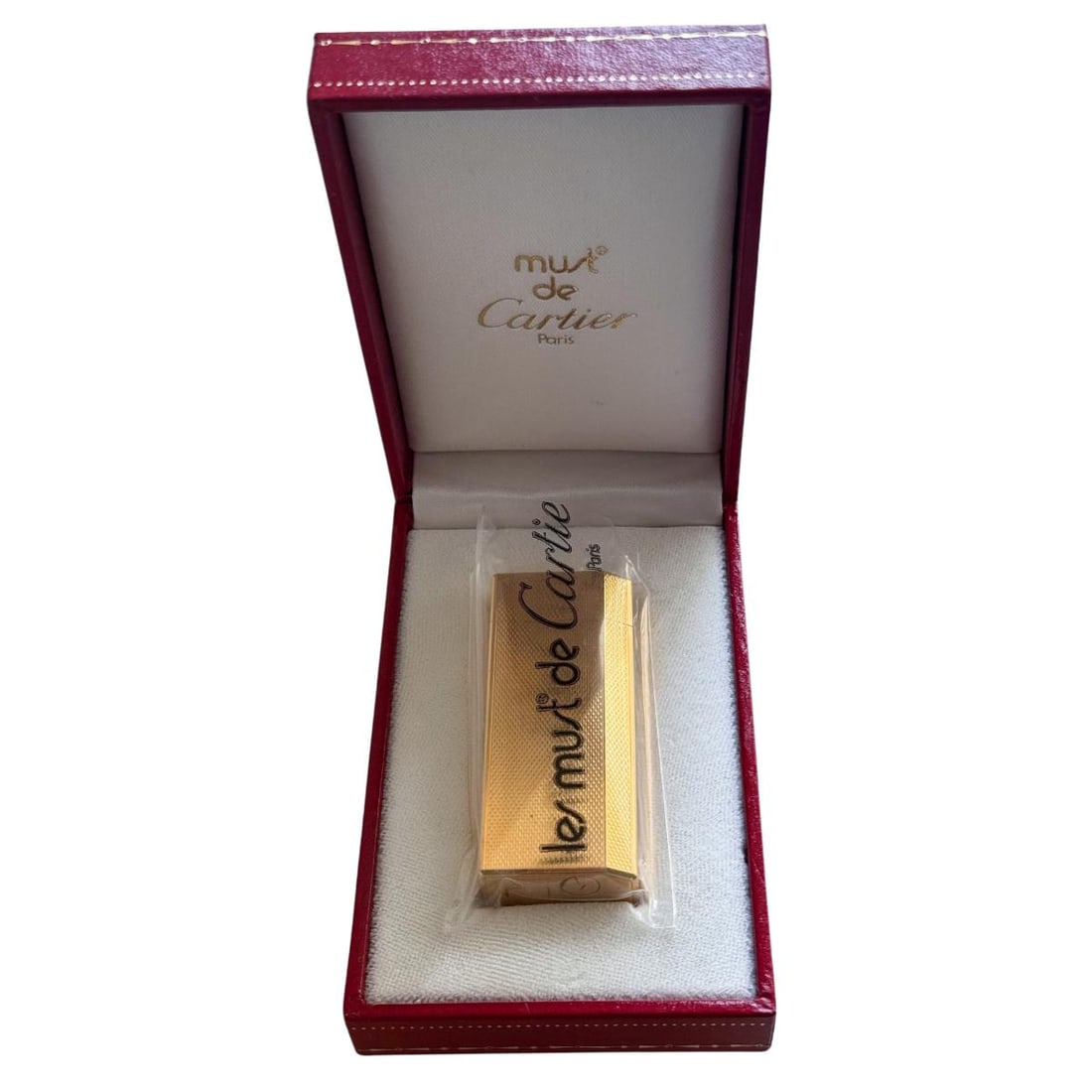 Must de Cartier Briquet Gold Plate Lighter: Metal : Gold Plate Designer : Cartier Measurements : Lighter is 59mm x 25mm x 13mm. Condition : Mint condition. Does not spark, needs refill. Additional : Comes with box and papers.