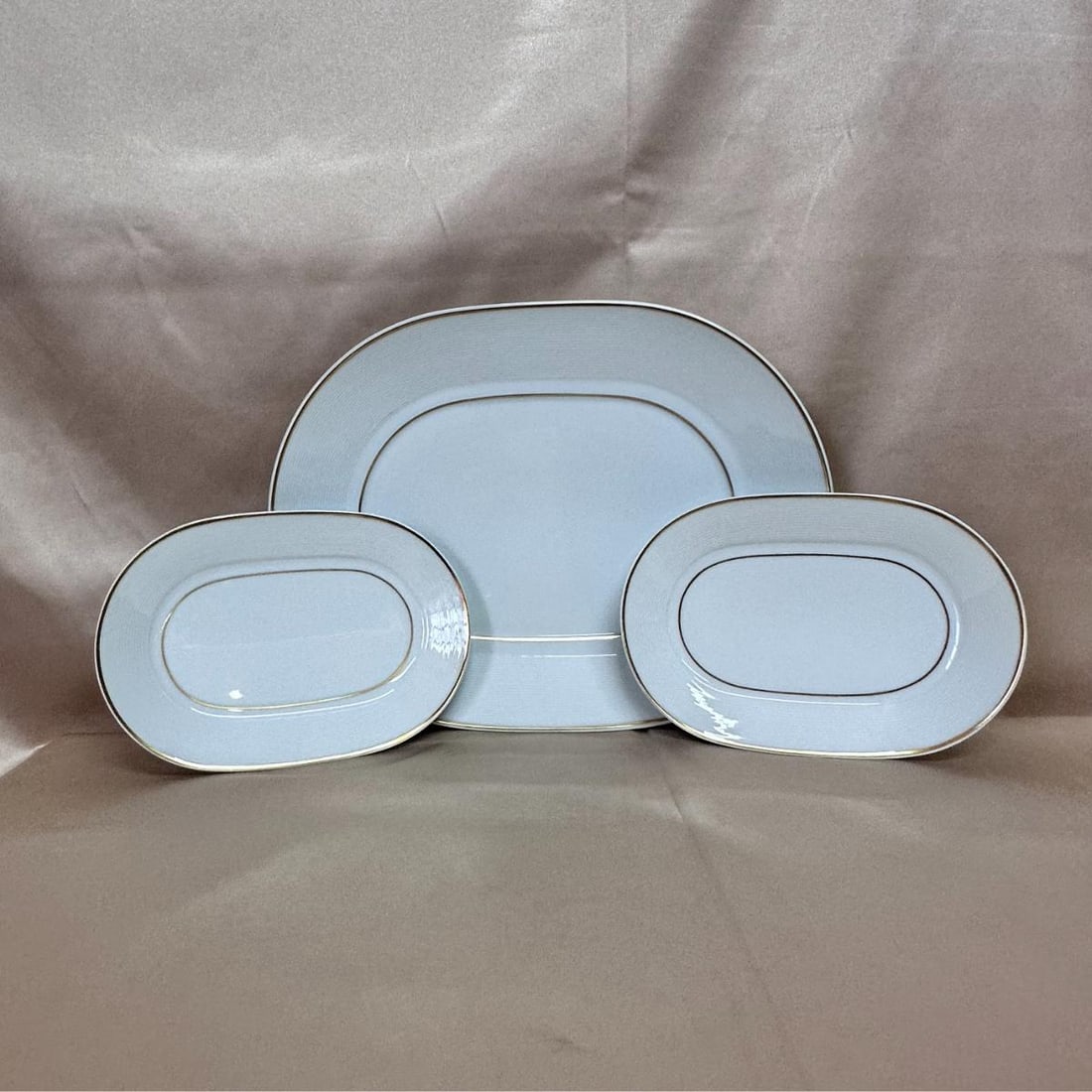 Bernardaud Limoges France White Gold Oval Service Plate Set of 3: Material : Porcelain Designer : Bernardaud Measurements : 13 3/8" x 10 1/4" and 8 1/4" x 5 3/4 Marked: : Bernardaud Limoges France -Marli or- Condition: : New Additional: None