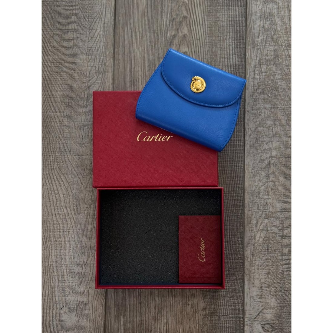 Cartier Panthere Blue Leather Wallet: Designer : Cartier Measurements : Wallet measures 3.75" x 5" when closed. Open - 9.75" end to end. Condition: : New, unworn. Additional: Comes in box with booklets.