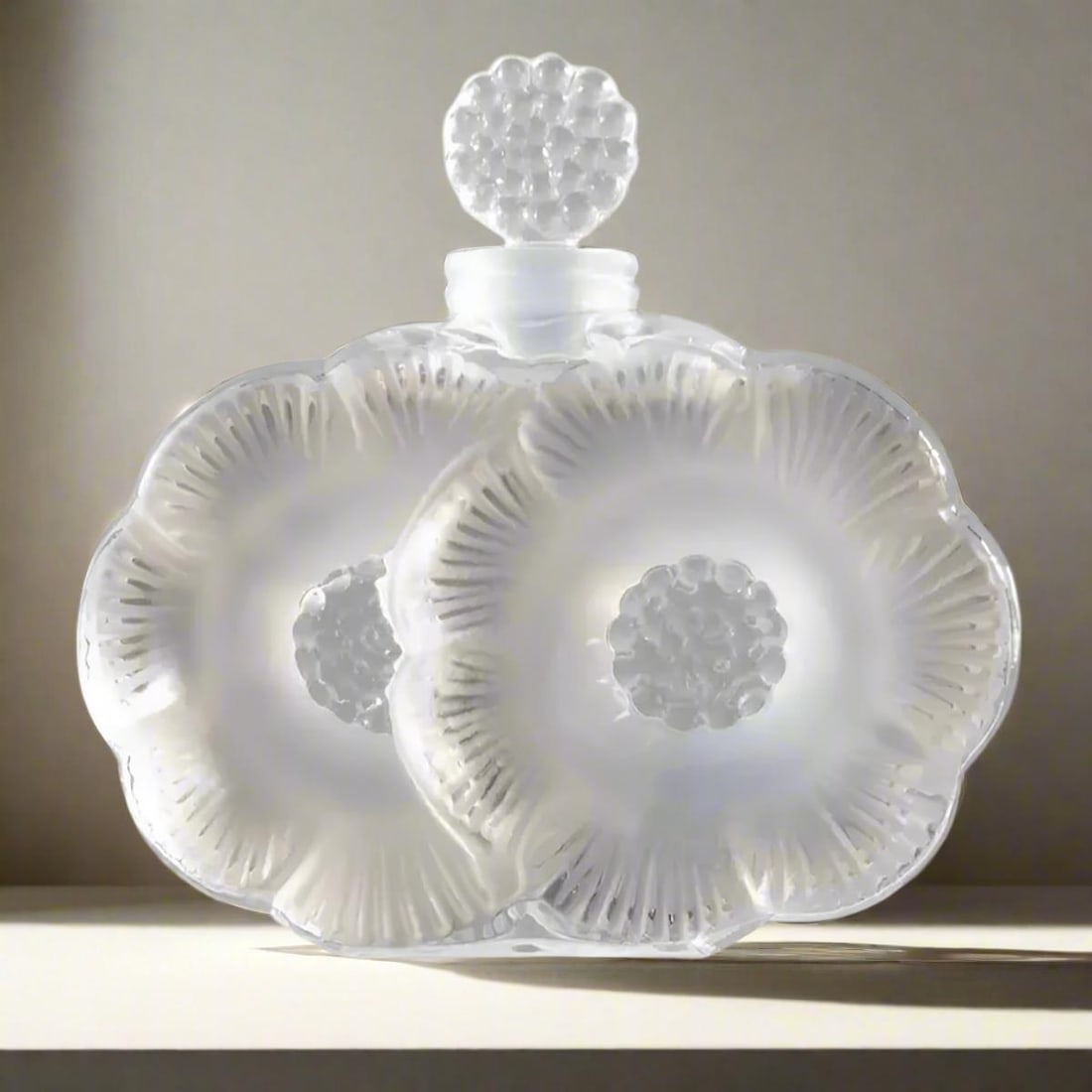 Lalique Crystal Two Flowers Perfume Bottle 1130100: Material : Crystal Designer : Lalique Measurements : D: 3 5/8'', H: 3 7/8'', Holds 1.6 ounces Marked: : Lalique Condition: : New/Store Sample Additional: Box