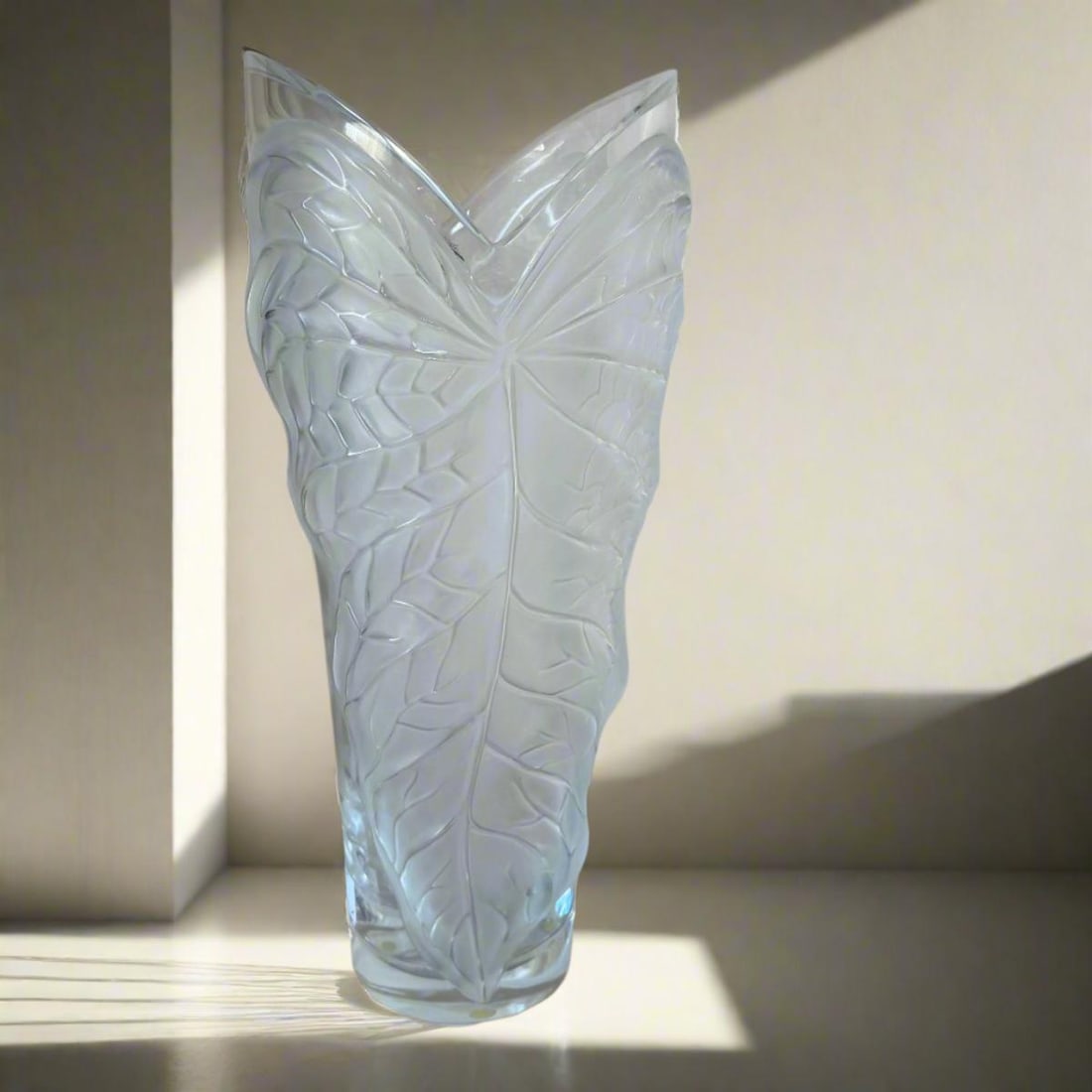 Lalique Crystal Anthurium Leaf Vase Large 1256200: Material : Crystal Designer : Lalique Measurements : H: 15 1/2'' Marked: : Lalique Condition: : New/Store Sample Additional: No box