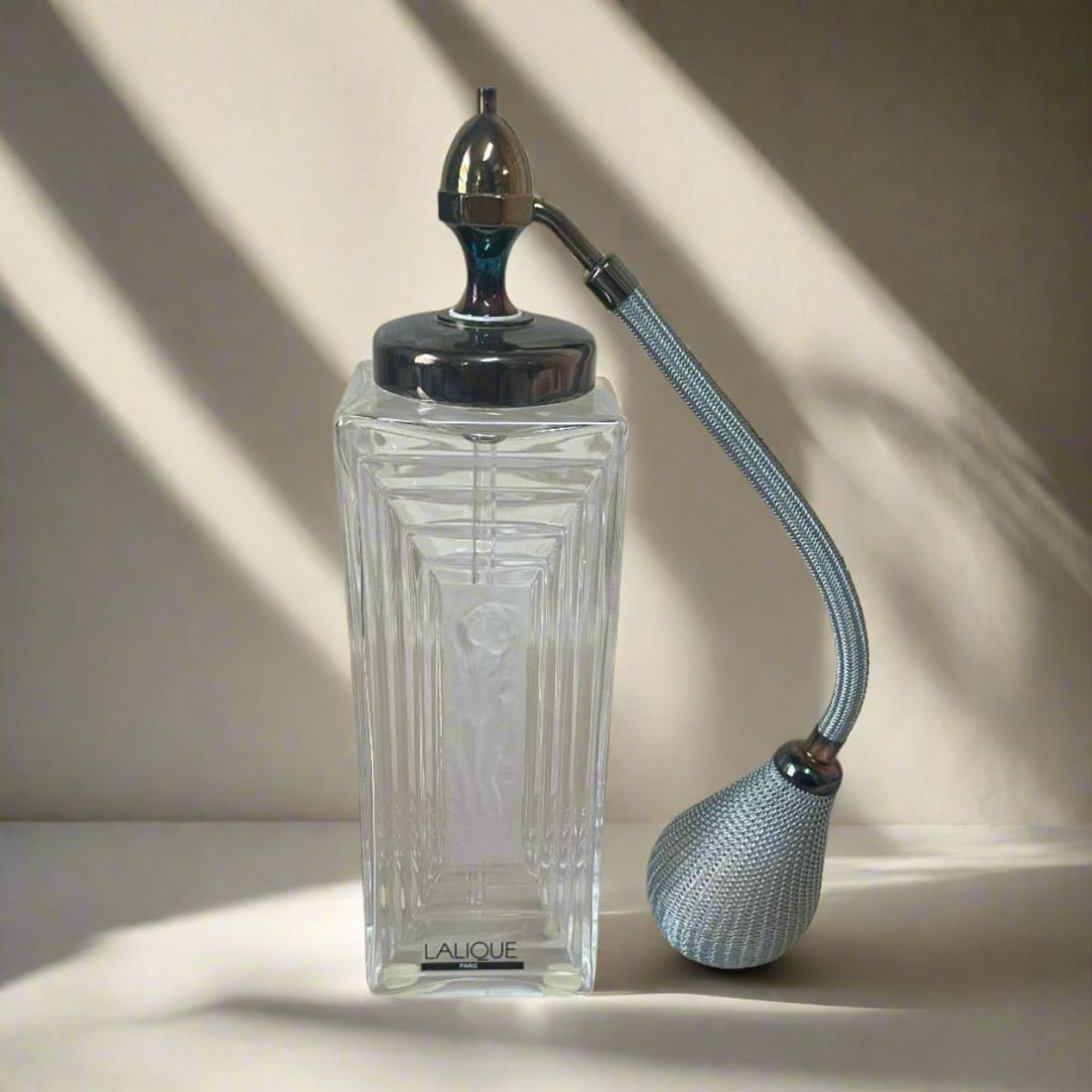 Lalique Crystal Duncan Perfume Bottle with Atomizer 1131100: Material : Crystal Designer : Lalique Measurements : D: 2 1/4'', H: 8'' Marked: : Lalique Condition: : New, store sample Additional: Comes with original box