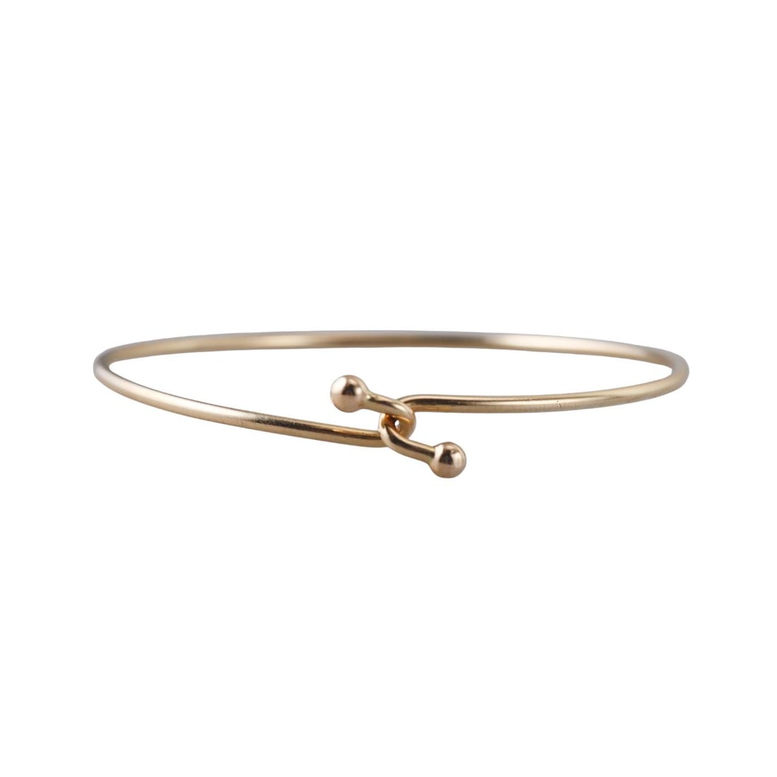 Tiffany & Co 14k Gold Hook Bangle Bracelet: Metal : 14k Yellow Gold Designer : Tiffany & Co Gemstone : None Measurements : Bracelet will fit approx. 6.5" wrist. Marked: : Tiffany & Co, 585. Weight: : 7.6 grams