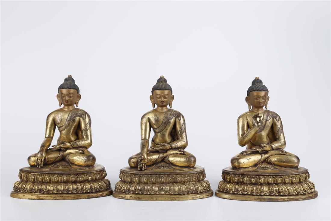 A GILT COPPER BUDDHA STATUE OF THREE PERIODS (1 of 10)