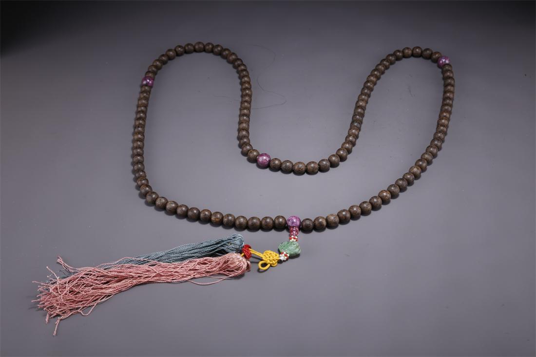 A STRING OF AGALWOOD BUDDHA BEADS. (1 of 9)