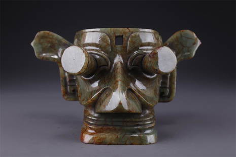 AN ANTIQUE JADE FACIAL MASK.: Antique Jade Facial Mask.