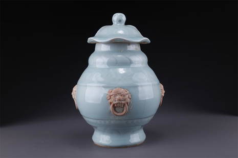 A GREEN CELADON LIDDED POT WITH BEAST DESIGN.: Green Celadon Lidded Pot with Beast Face Design.