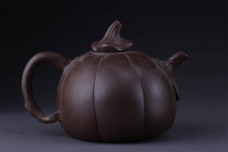 A RIDGED MELON-SHAPED PURPLE CLAY TEAPOT.: Ridged Melon-Shaped Purple Clay Teapot.