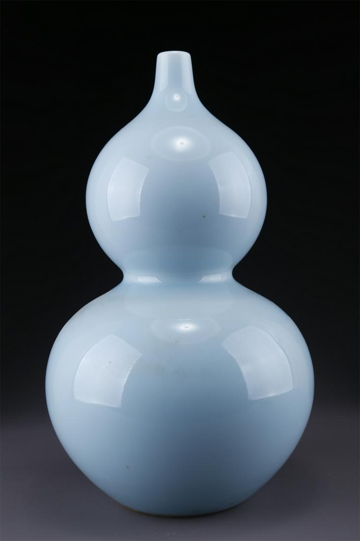 A CELESTE GLAZED GOURD-SHAPED PORCELAIN BOTTLE. (1 of 9)
