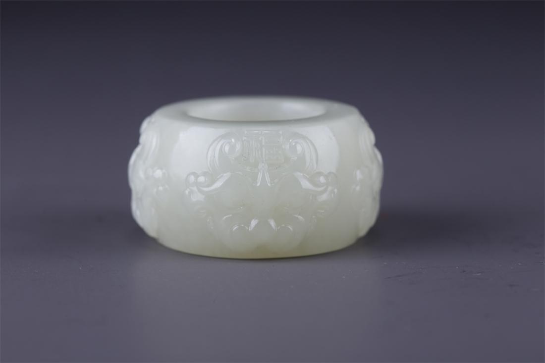 A HETIAN JADE THUMB RING WITH BEAST DESIGN. (1 of 9)