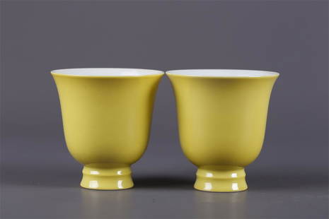 A PAIR OF YELLOW GLAZED BELL-SHAPED CUPS.: A Pair of Yellow Glazed Bell-Shaped Porcelain Cups.